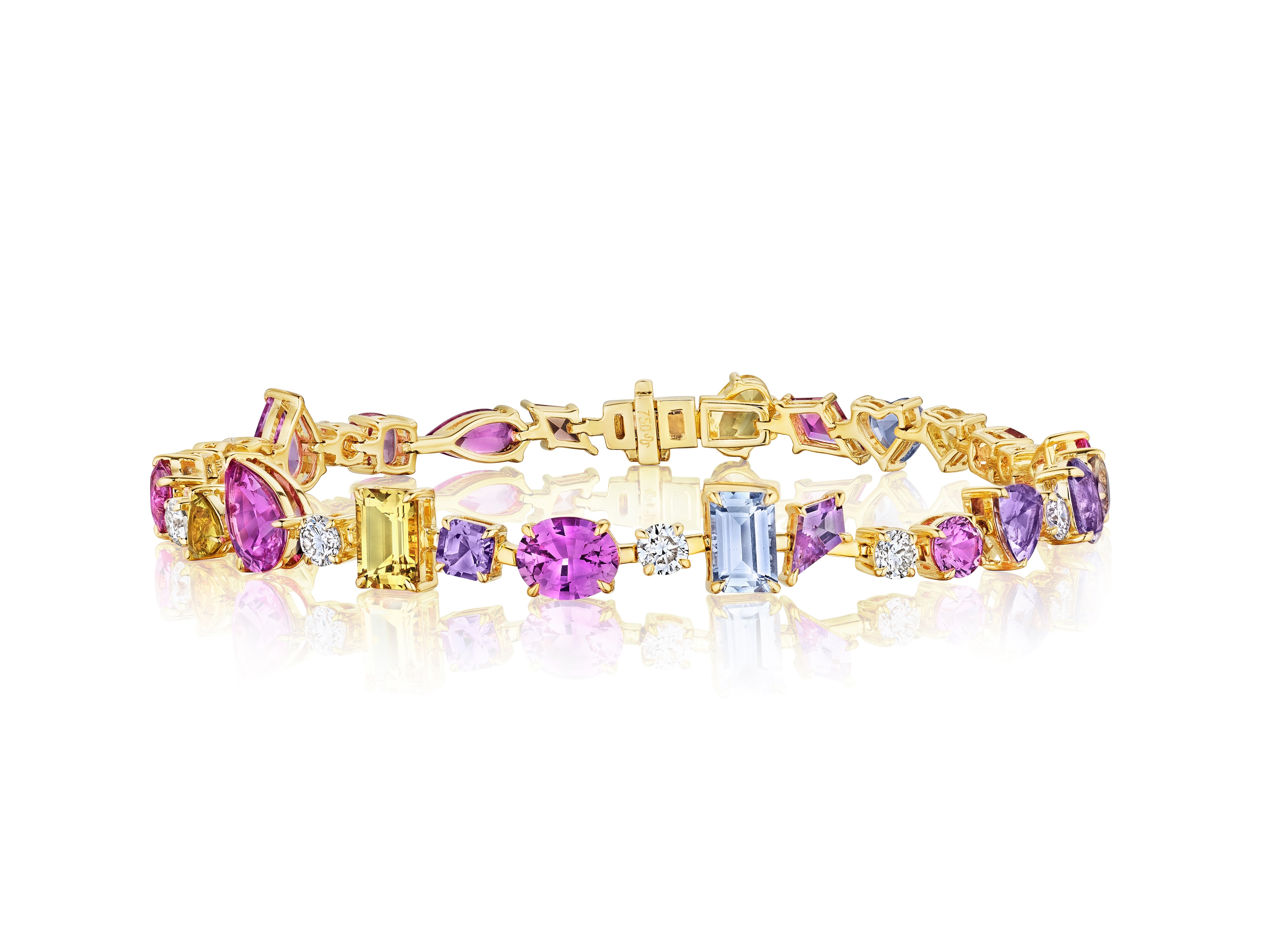 A statement piece, the Chroma Kaleidoscope Mixed Shape Sapphire Tennis Bracelet in Yellow Gold showcases vibrant purple, pink, yellow, and light blue sapphires arranged in a bold 18K yellow gold repeating pattern.