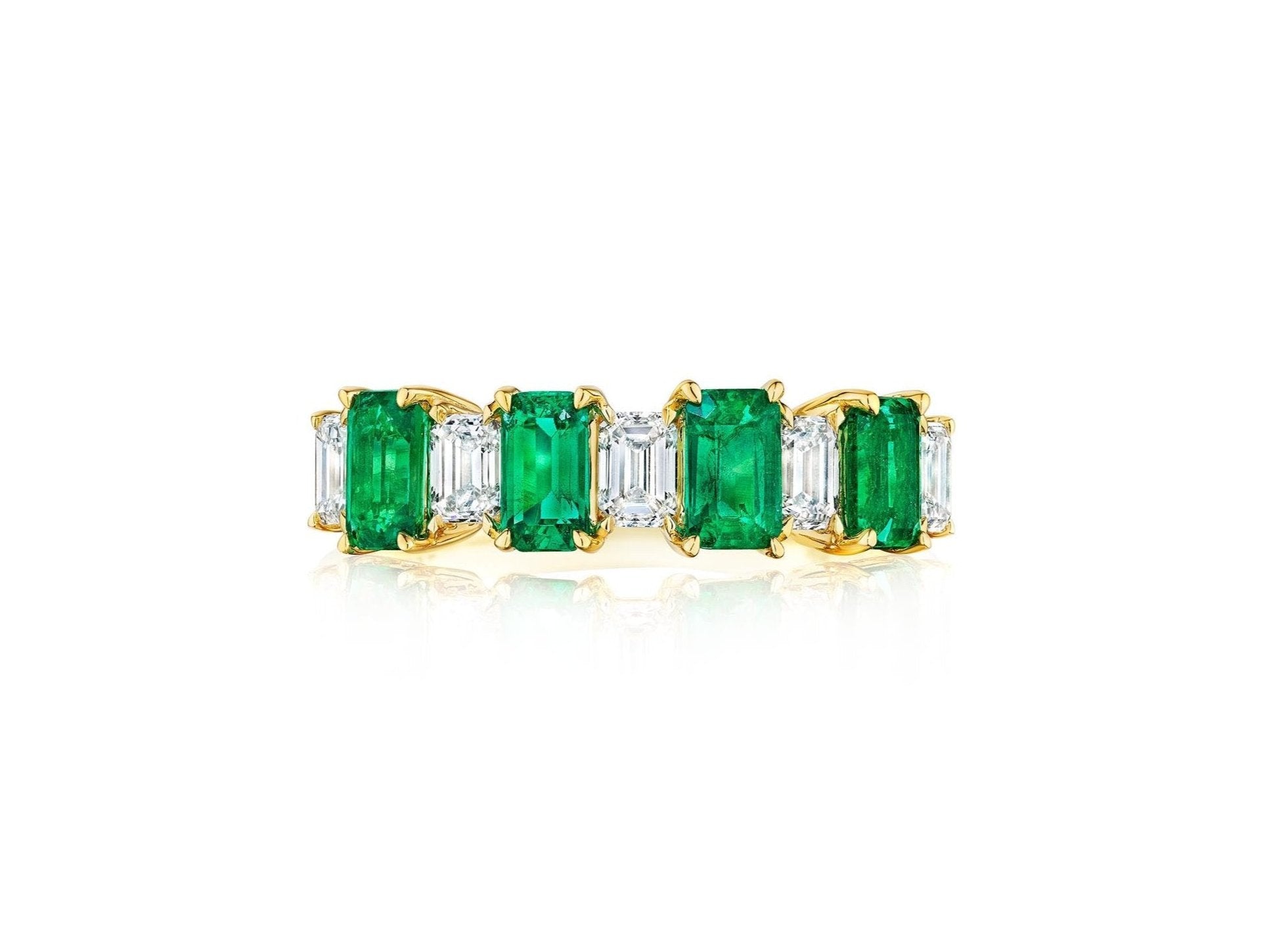 The Chroma Alternating Emerald and Diamond Half Eternity Band showcases rectangular green emeralds and emerald cut diamonds in a row, set in 18K gold with a classic, symmetrical design.