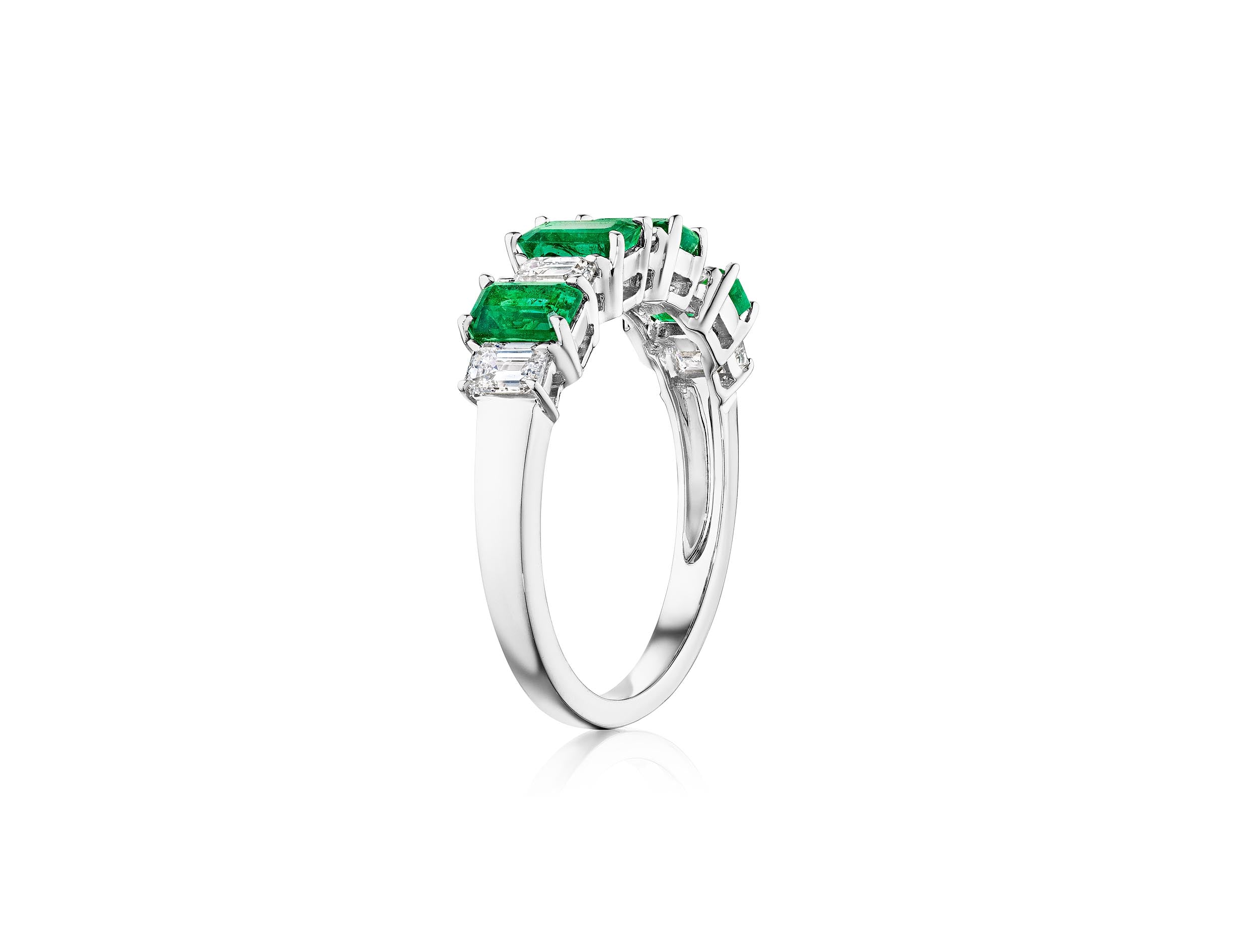 The Chroma Alternating Emerald and Diamond Half Eternity Band is a silver ring with five rectangular green emeralds separated by small clear diamonds, shown on a white background.