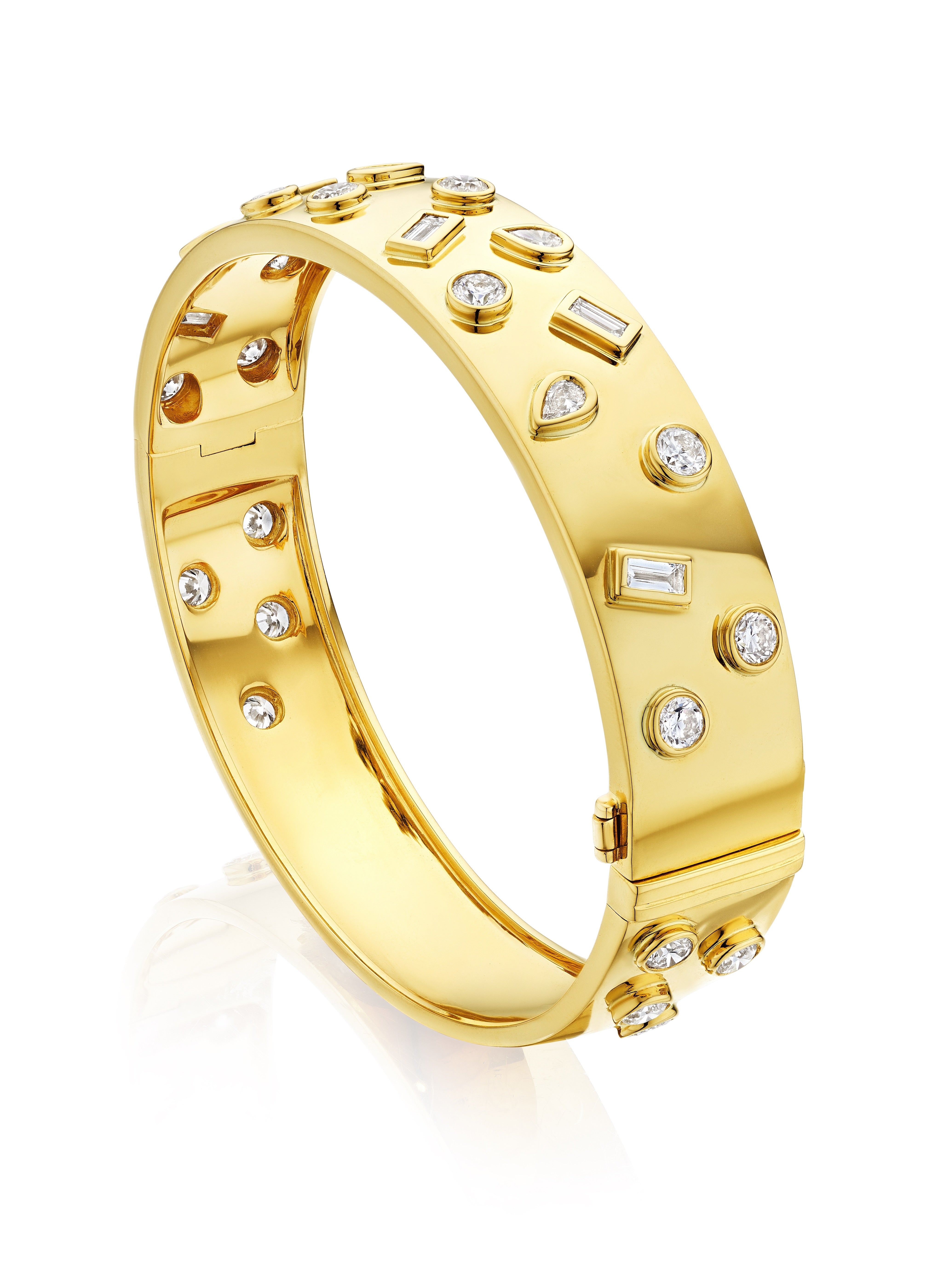 The Bezel Set Mixed Shape Diamond Bangle in Yellow Gold features round, baguette, and teardrop diamonds set in polished 18K yellow gold, finished with a hinged clasp for a sleek look.