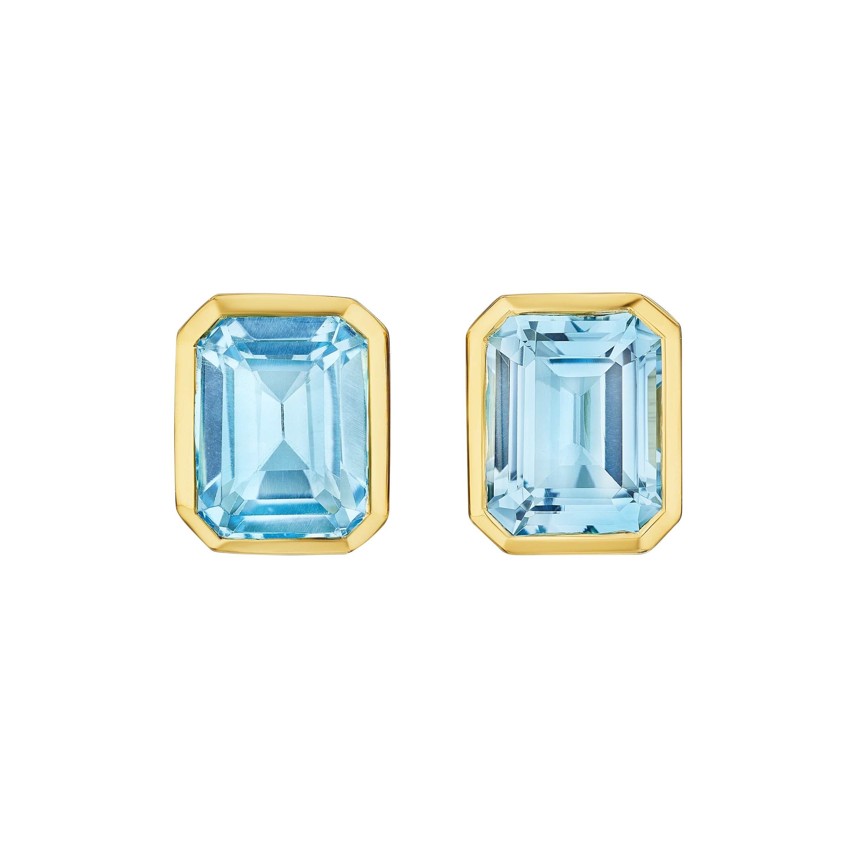 The Bezel Set Emerald Cut Aquamarine Stud Earrings in Yellow Gold showcase rectangular aquamarine gemstones in sleek bezel settings, displayed on a white background.
