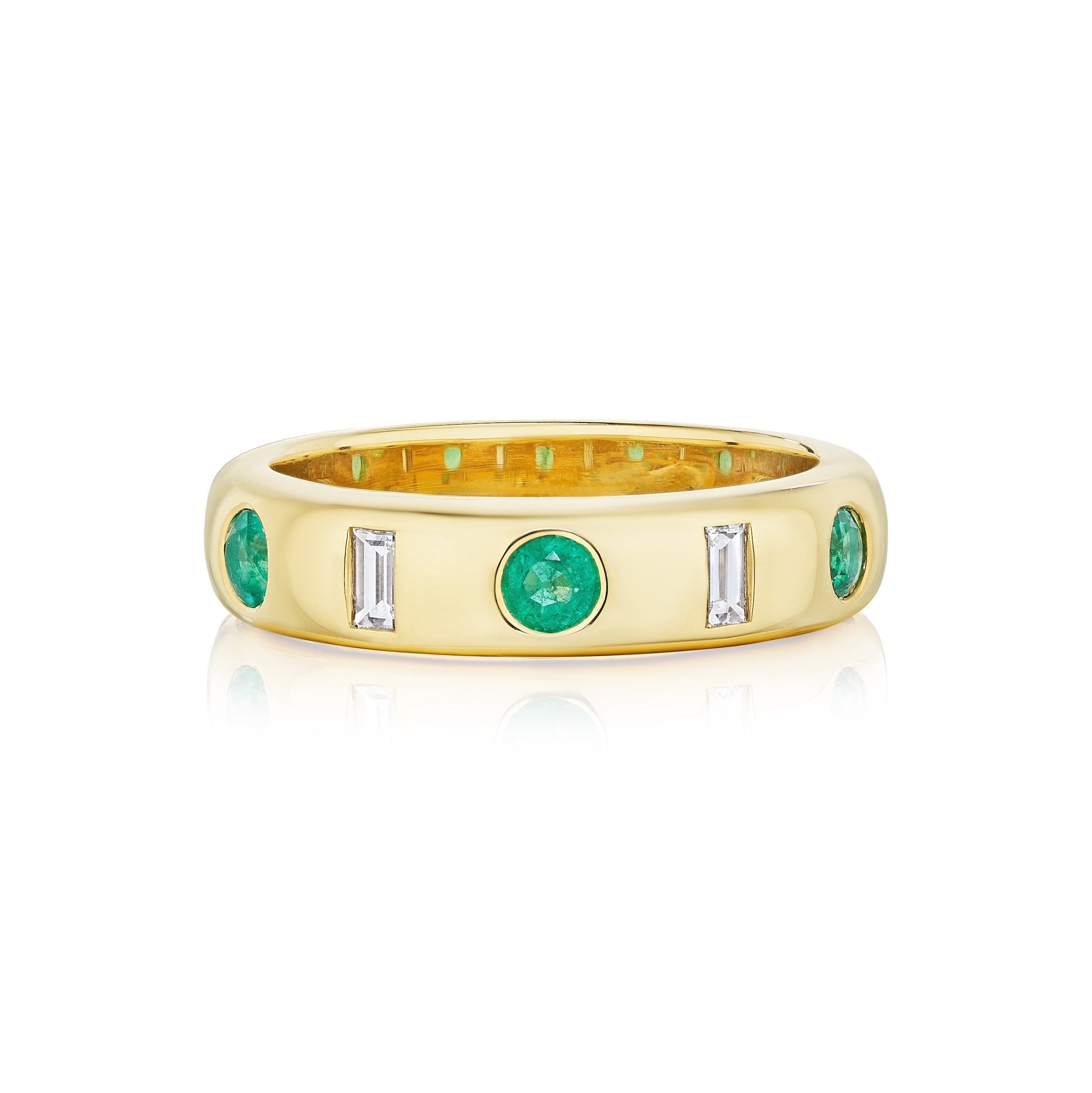 The Bespoke Burnish Set Baguette Diamond and Round Emerald Band in Yellow Gold features three round emeralds and two baguette diamonds in an alternating pattern, finished with a smooth, polished shine, shown on a white background.