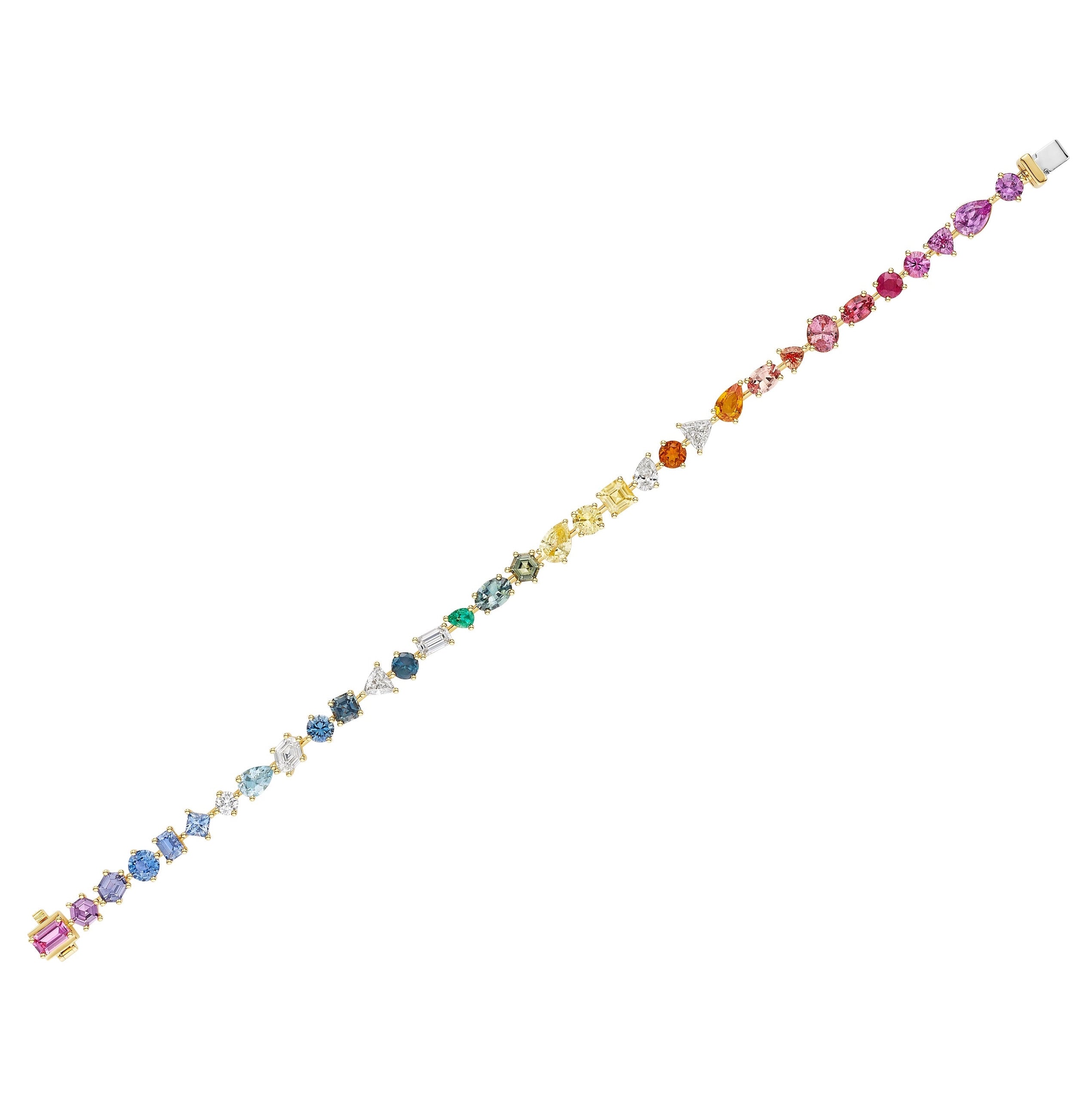 The Bespoke Mixed Shape Multicolor Sapphire and Diamond Tennis Bracelet in yellow gold showcases sapphires and diamonds in a rainbow gradient, with various shapes arranged from purple to light blue stones.