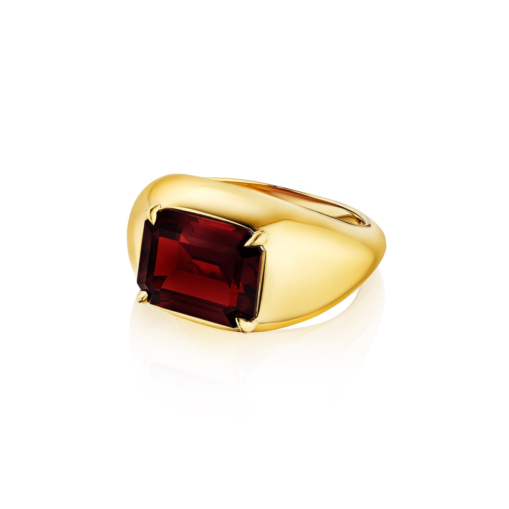 The Bombé Ring features an east-west set emerald cut ruby at its center on a wide 18k yellow gold band, displayed against a white background.
