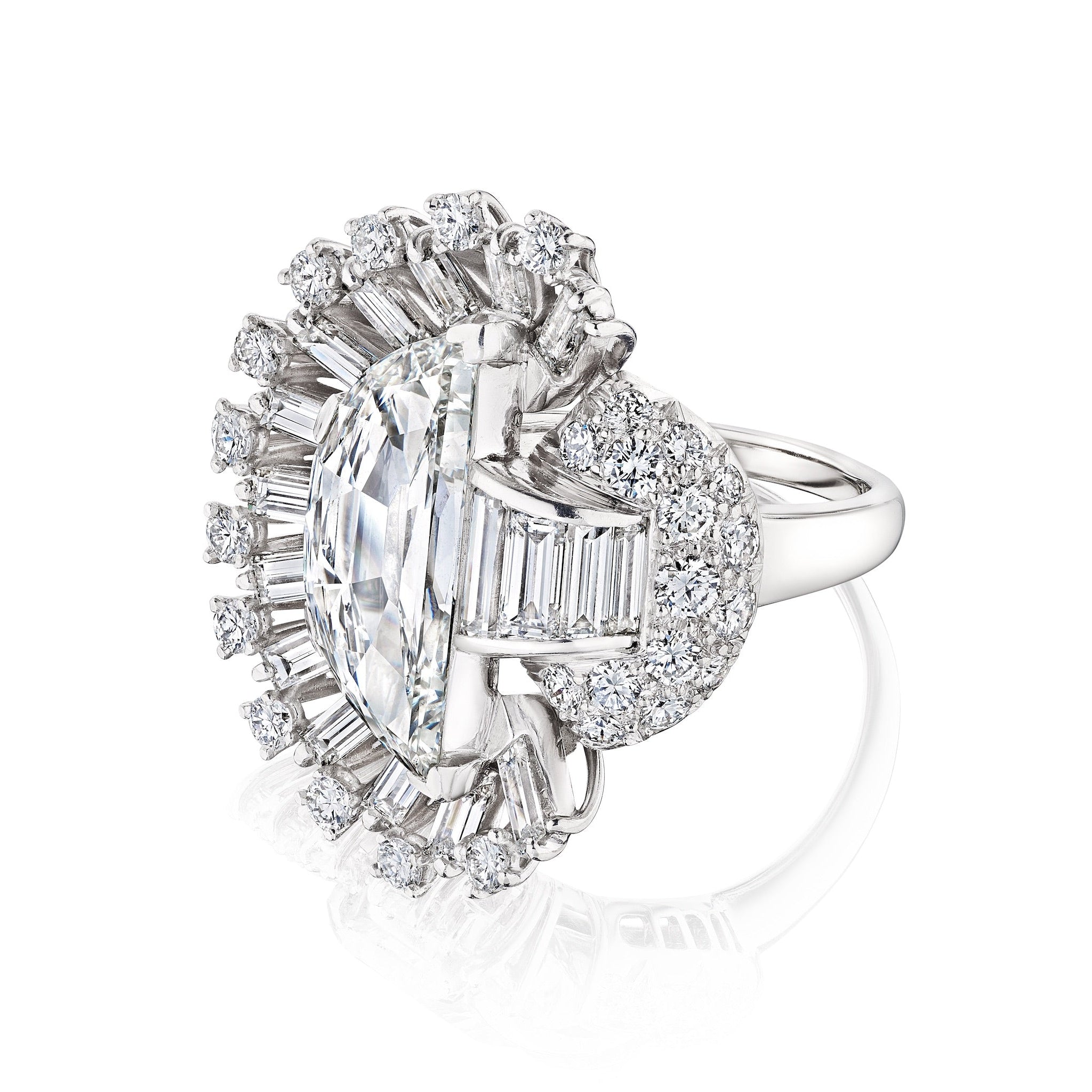 The Oscar Heyman & Brothers Diamond Ring features a striking oval diamond center, accented by a halo of round and baguette diamonds in an intricate white gold setting for a radiant, modern look.