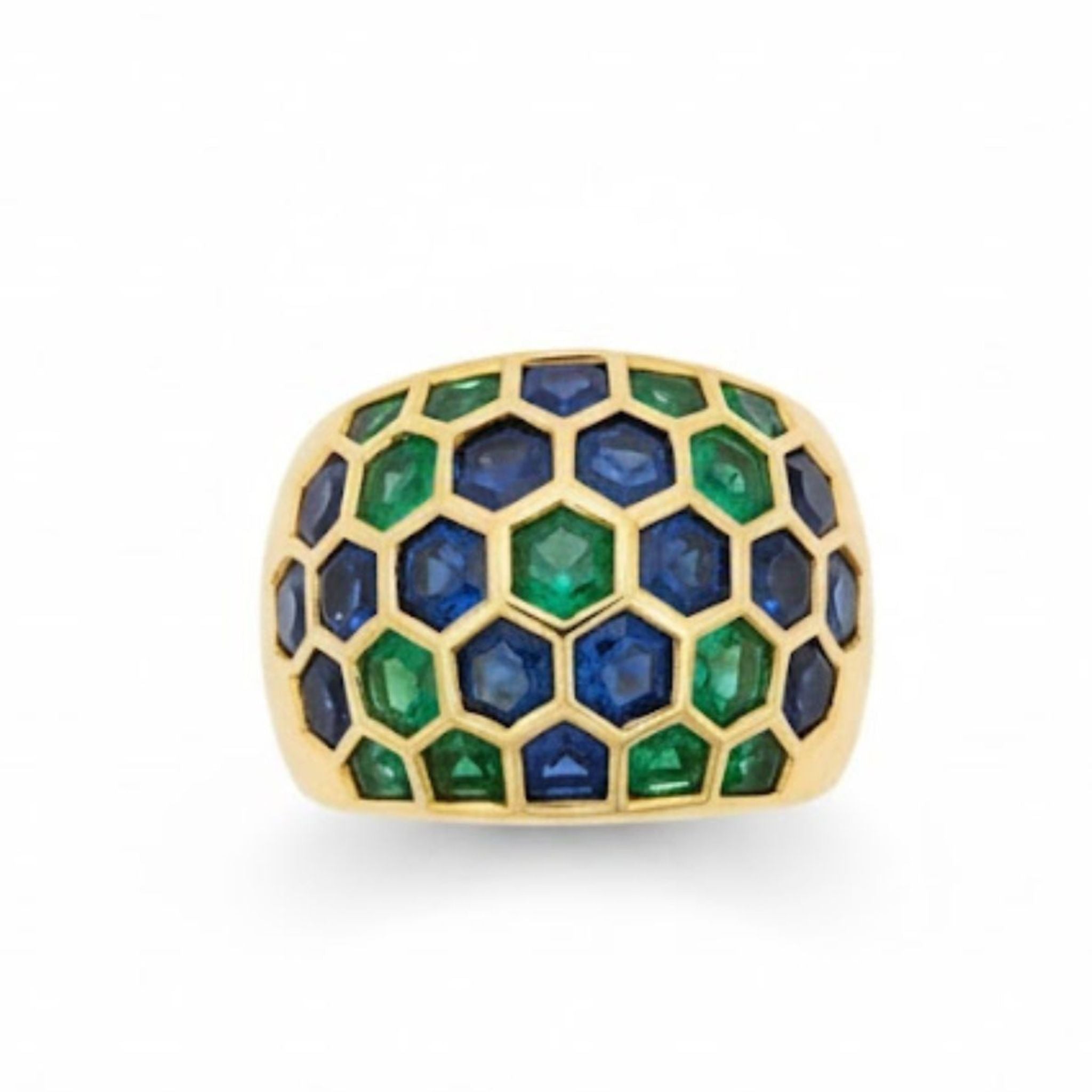 The Sabbadini Emerald and Sapphire Ring is a honeycomb-designed piece crafted in 18K yellow gold with alternating sapphire and emerald gemstones, shown against a plain white background.