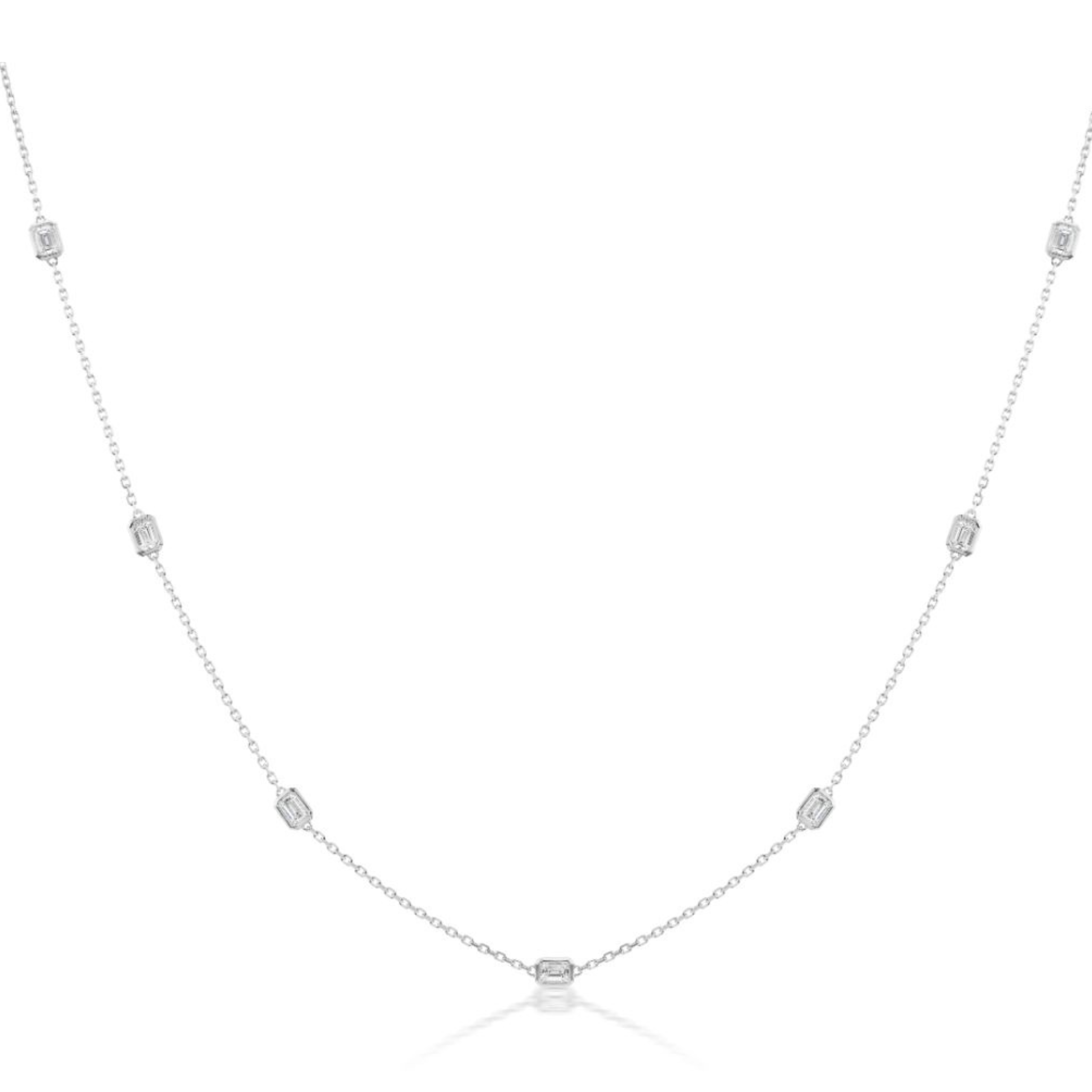 The Serpentine Station Necklace with Emerald Cut Diamonds in White Gold features a fine chain with evenly spaced small emerald-cut diamond accents, crafted in 18K white gold and shown on a white background.