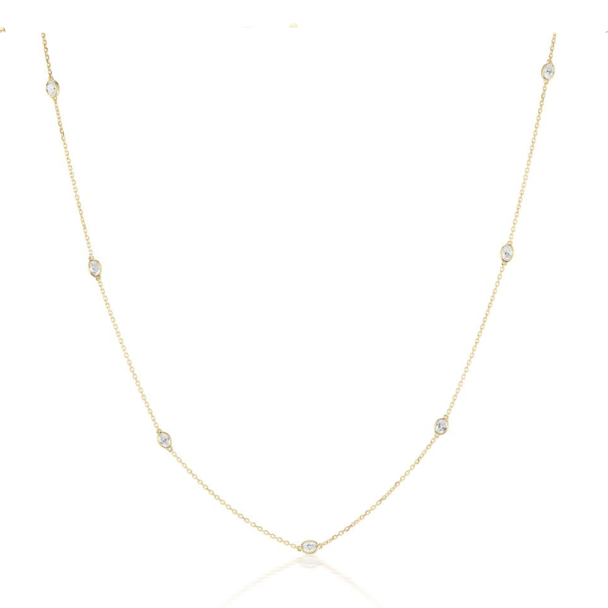 The Serpentine Station Necklace features oval diamonds set in 18K gold, evenly spaced along the chain and displayed on a white background.