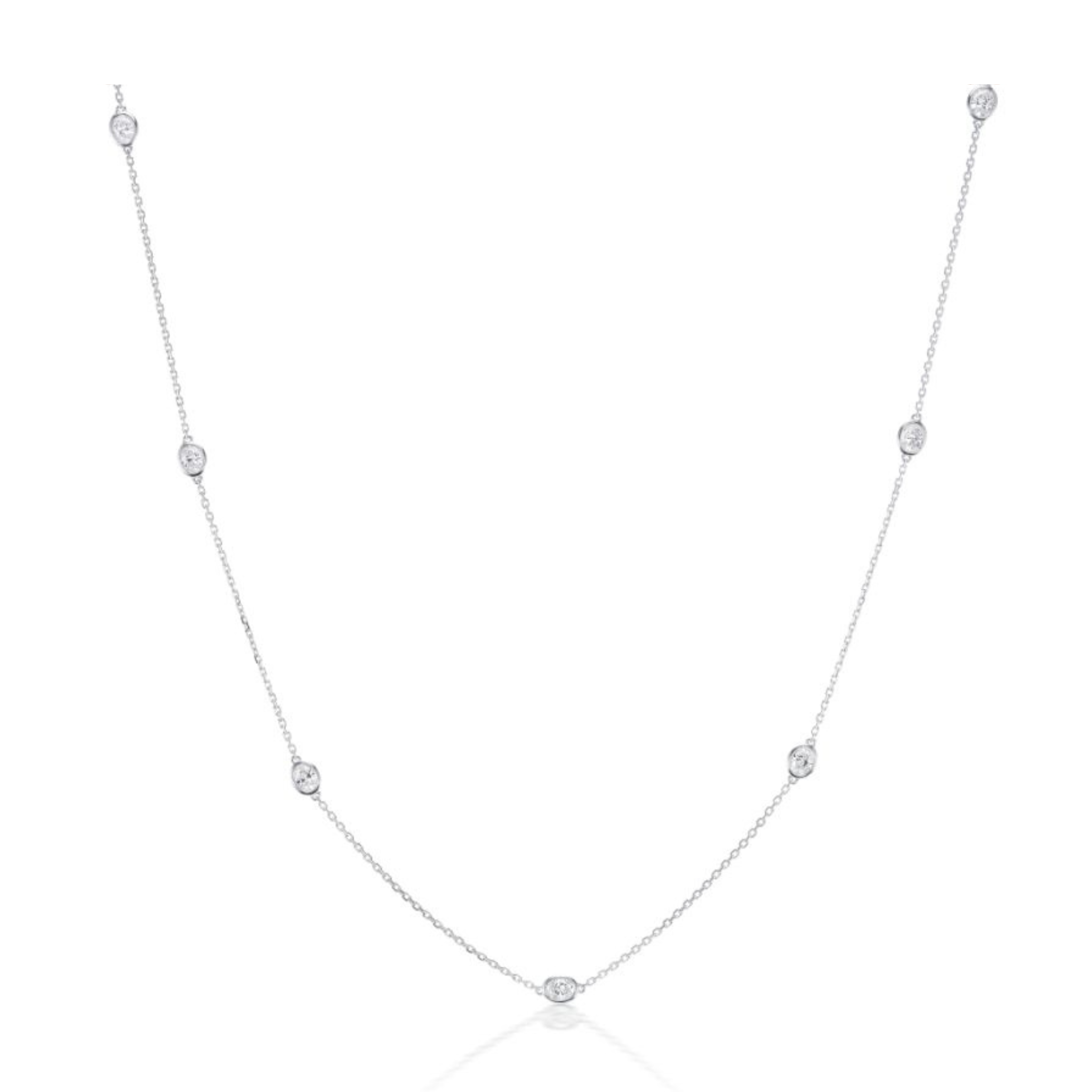 The Serpentine Station Necklace features a silver chain with evenly spaced oval diamonds, bezel-set along its length, displayed on a white background.