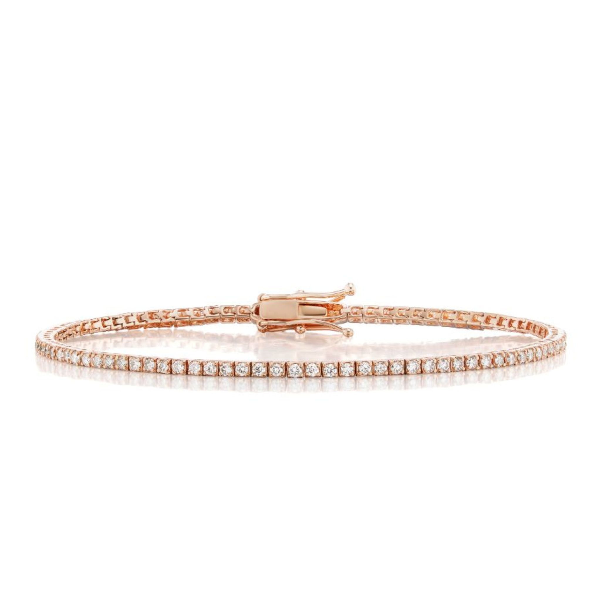 The Skinny Round Brilliant Diamond Tennis Bracelet is crafted in 14k gold, featuring a single row of small round white diamonds and secured with a clasp.