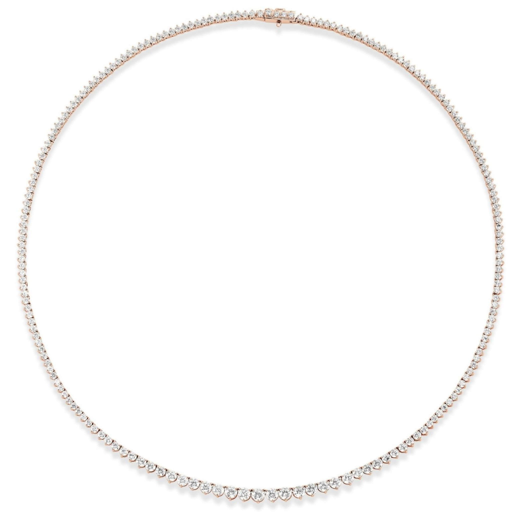 The Small Graduated Round Diamond Tennis Necklace features a delicate 18k gold band adorned with closely set, small round diamonds and finished with a subtle clasp.