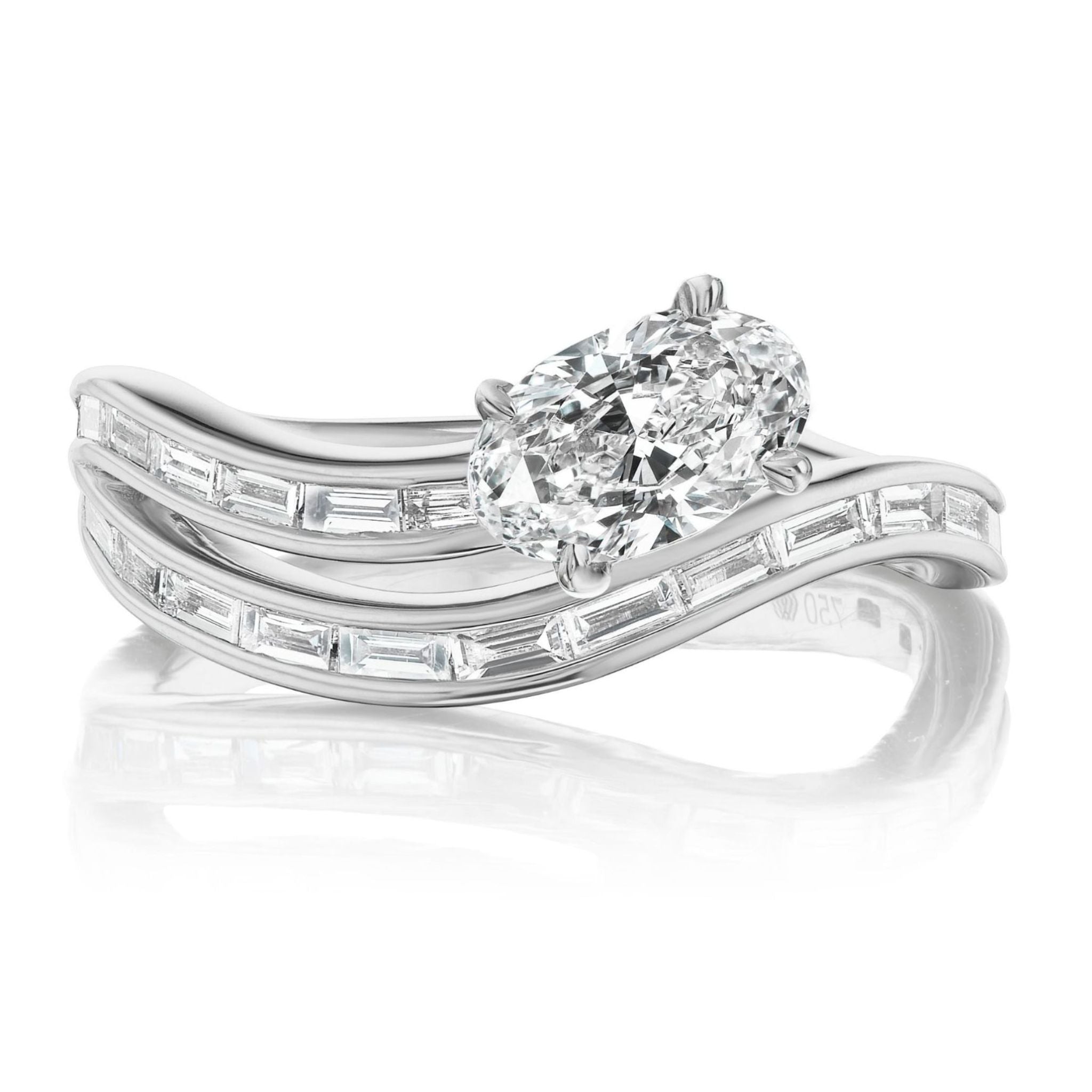 The Snake Wave Channel Set Baguette Diamond Ring with Oval Diamond features a striking oval diamond centerpiece and two wavy gold bands adorned with baguette diamonds, beautifully stacked for an elegant look.