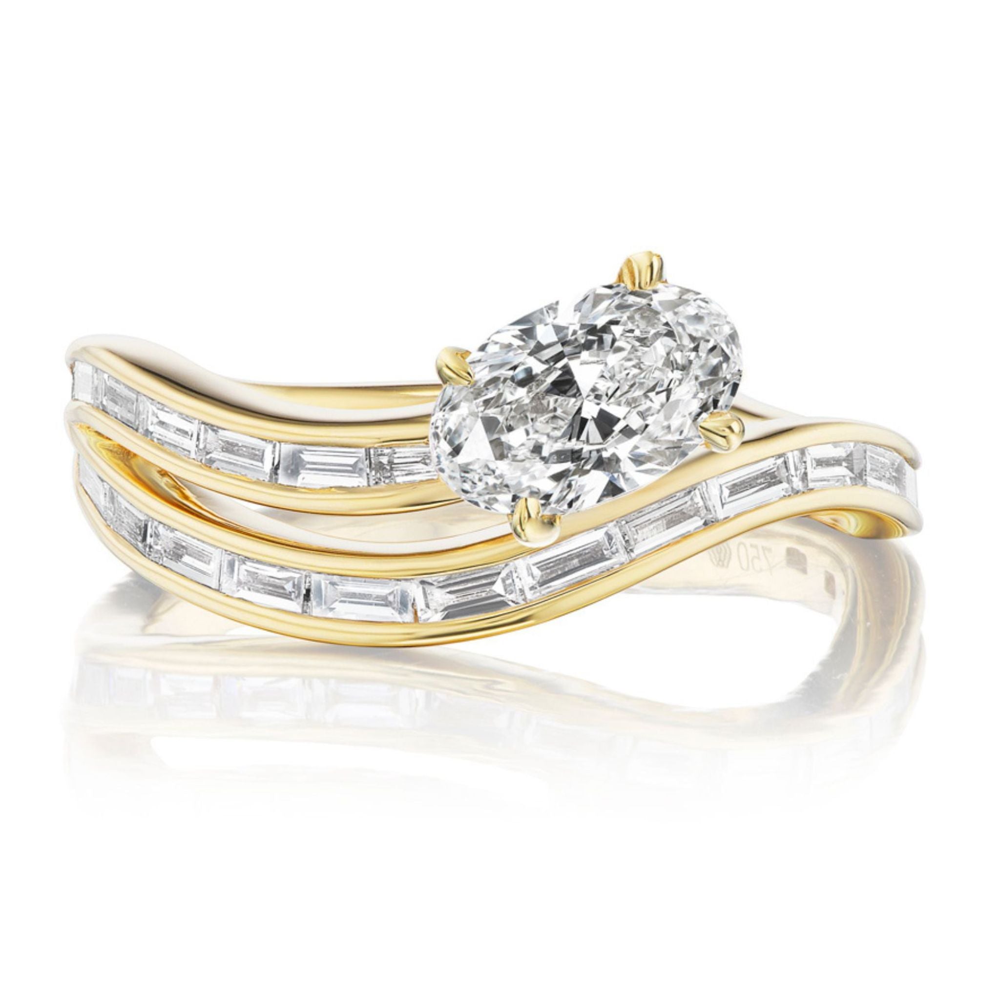 The Snake Wave Channel Set Baguette Diamond Ring with Oval Diamond features a large oval diamond center and a matching curved band, both accented with rectangular baguette-cut diamonds.