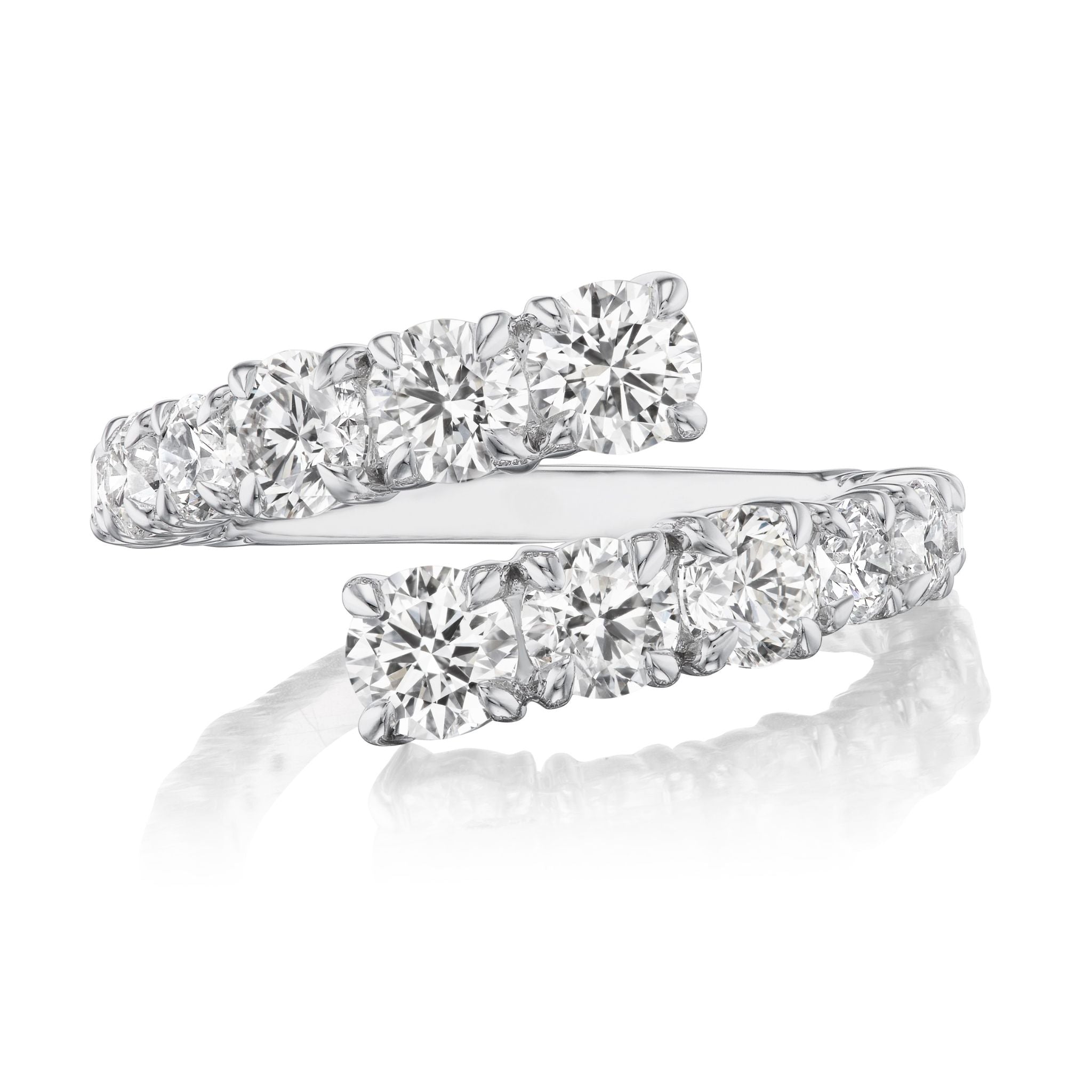 The Graduated Round Diamond Wraparound Ring in White Gold showcases two rows of G-H color round diamonds set side by side, overlapping at the ends, and is displayed on a reflective white surface.