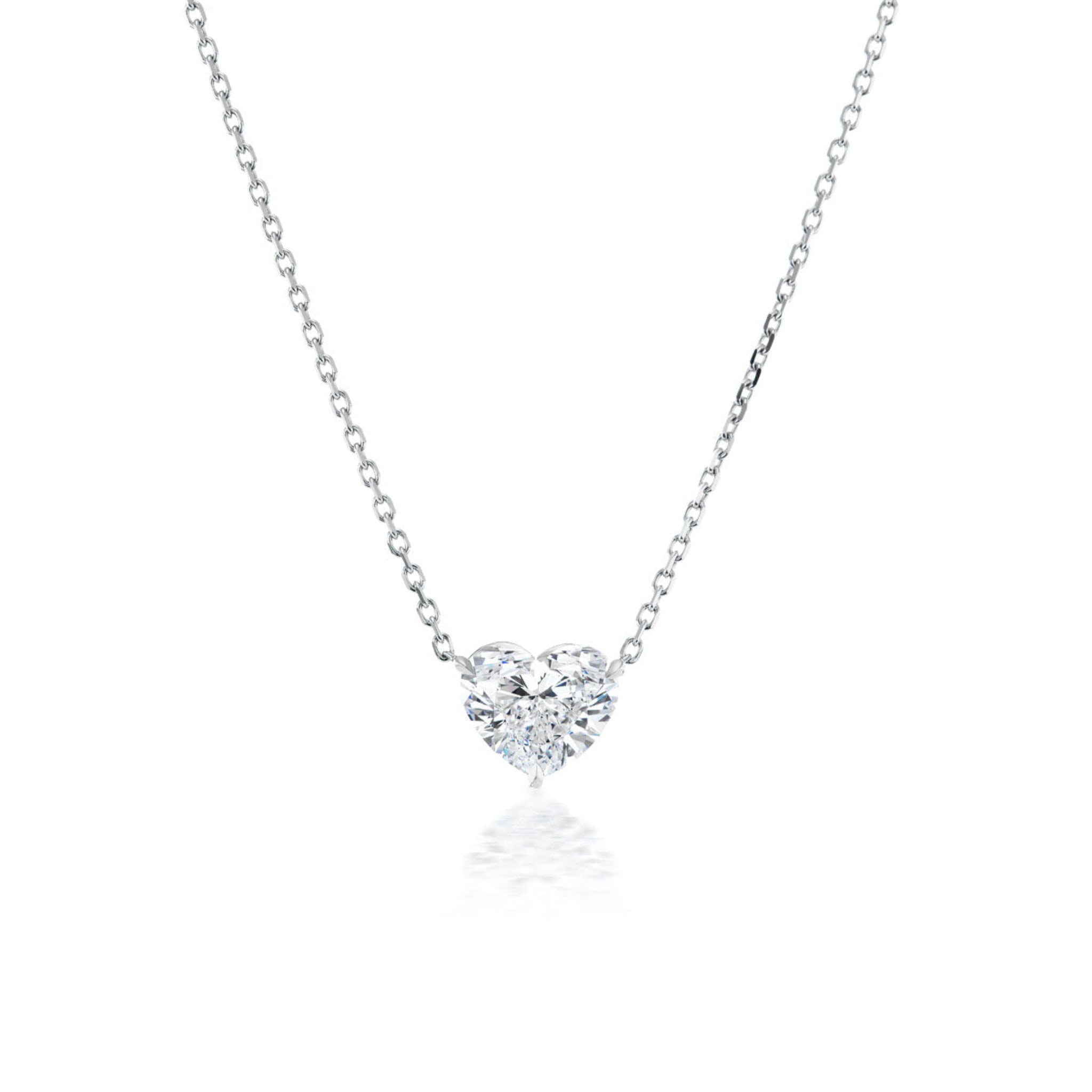 The Heart Diamond Solitaire Pendant is an elegant 18k gold necklace with a sparkling heart-shaped diamond, shown on a white background.