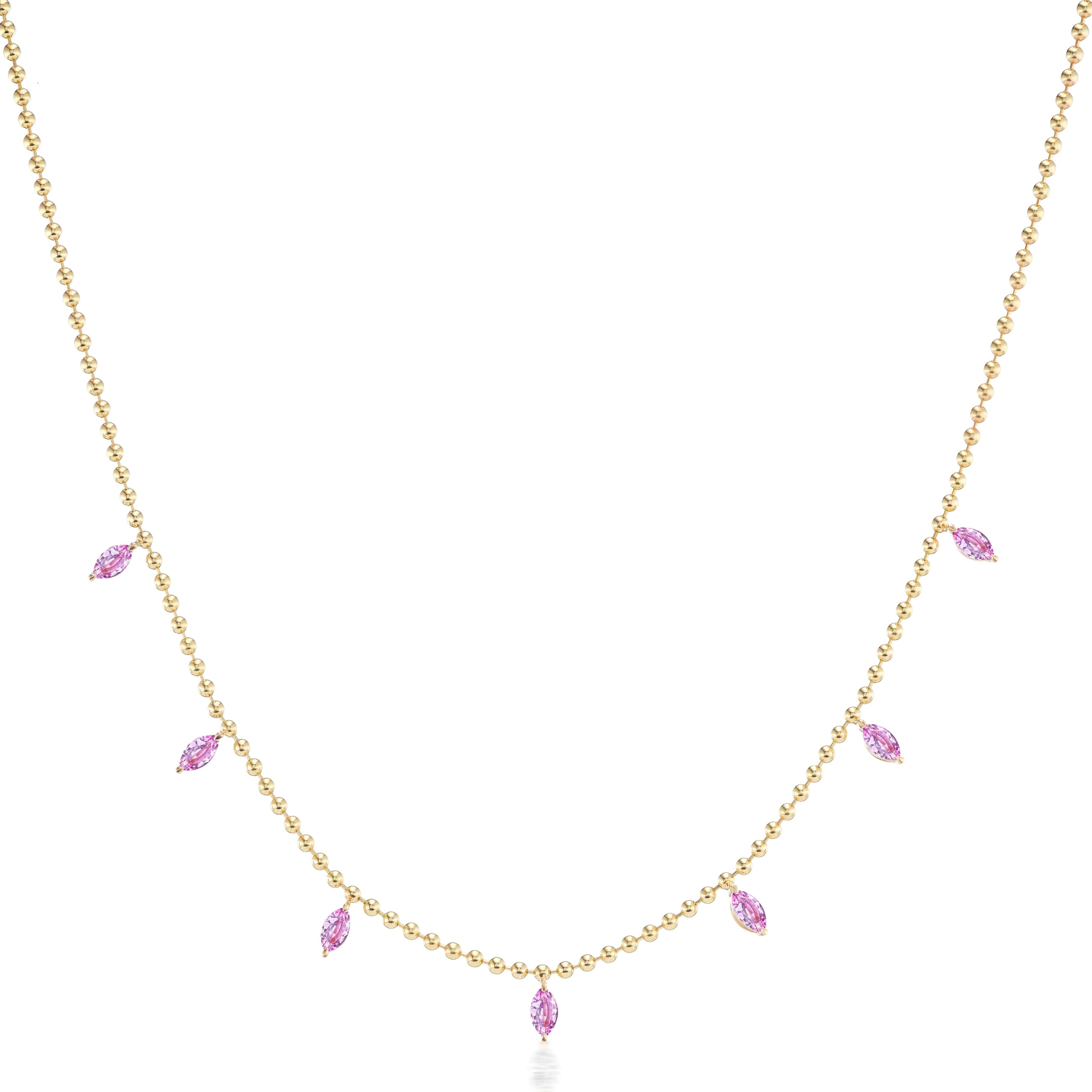 The Spike Ball Chain Necklace in Yellow Gold features seven marquise-shaped pink sapphires, each set in a gold frame and spaced along the lower part of the delicate 18K gold chain.