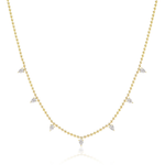 The Spike Ball Station Chain Necklace with Pear Diamonds is an 18k gold necklace featuring evenly spaced small pear-shaped diamonds, shown on a plain white background.