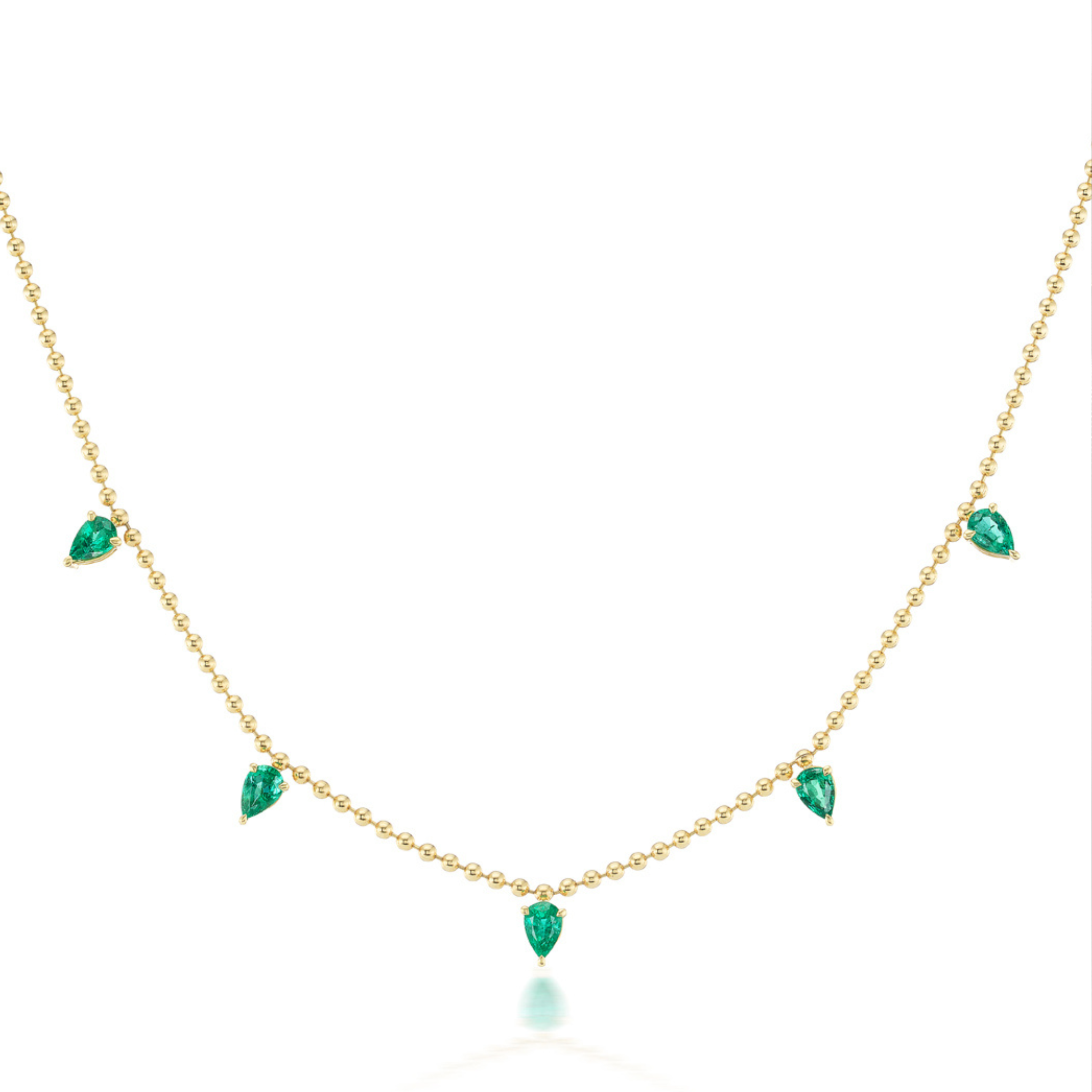 The Spike Necklace in Yellow Gold with Pear Emeralds features five evenly spaced pear-shaped emeralds in 18K yellow gold. Its minimalist design highlights the elegant teardrop gems for a refined, sophisticated look.