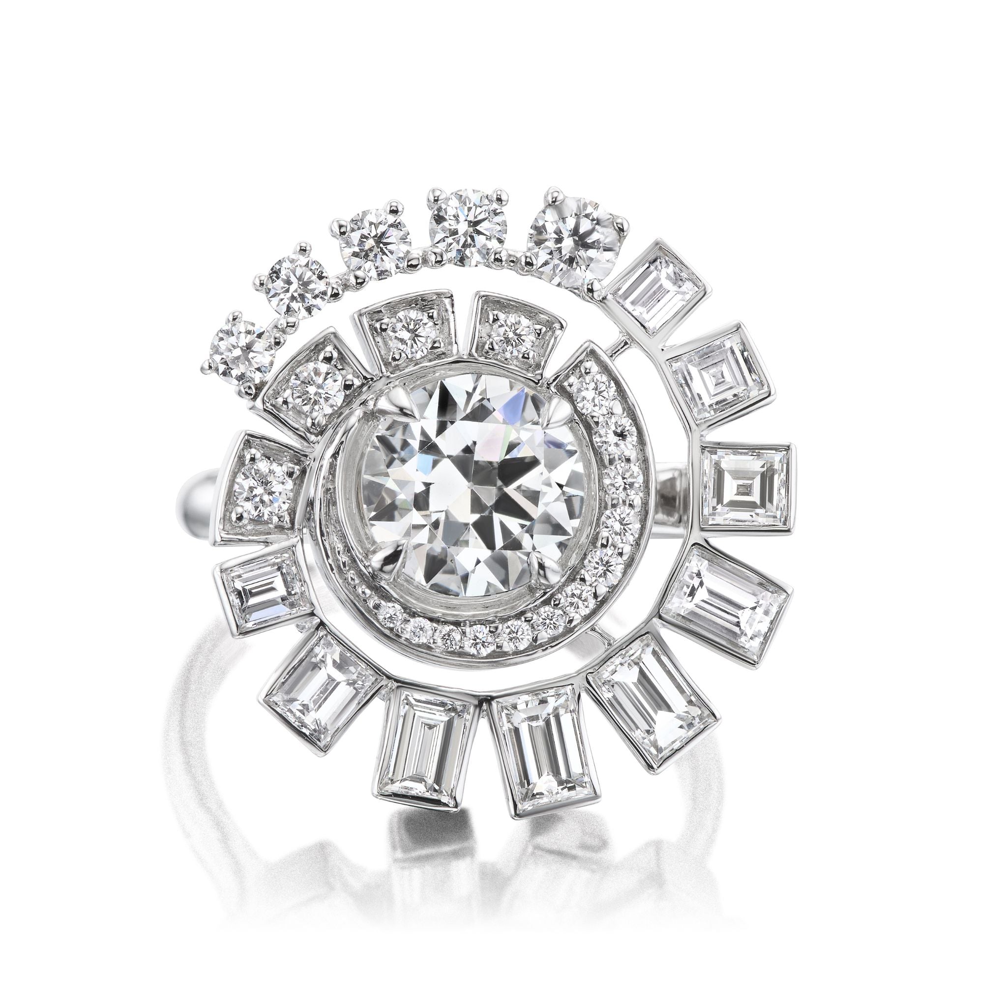 The Spiral Ring in White Gold features a central round brilliant diamond, accented by a swirl of smaller round and baguette diamonds in a modern, intricate design.