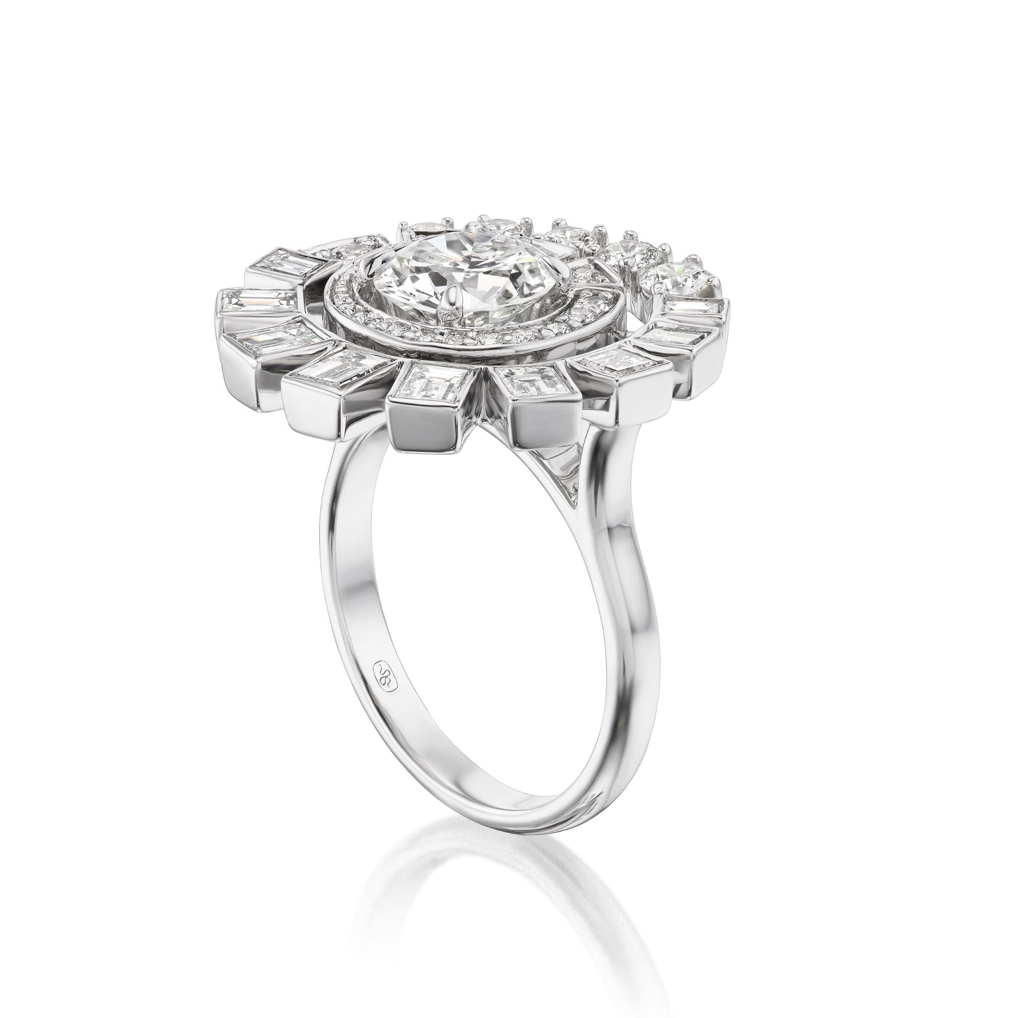 The Spiral Ring in White Gold features round brilliant and baguette diamonds arranged in an elaborate halo setting, displayed against a white background.