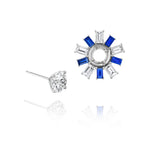Confetti Ear Jackets in white gold feature one stud with an emerald cut diamond and the other with a circular design of alternating blue sapphires and diamonds radiating outward.