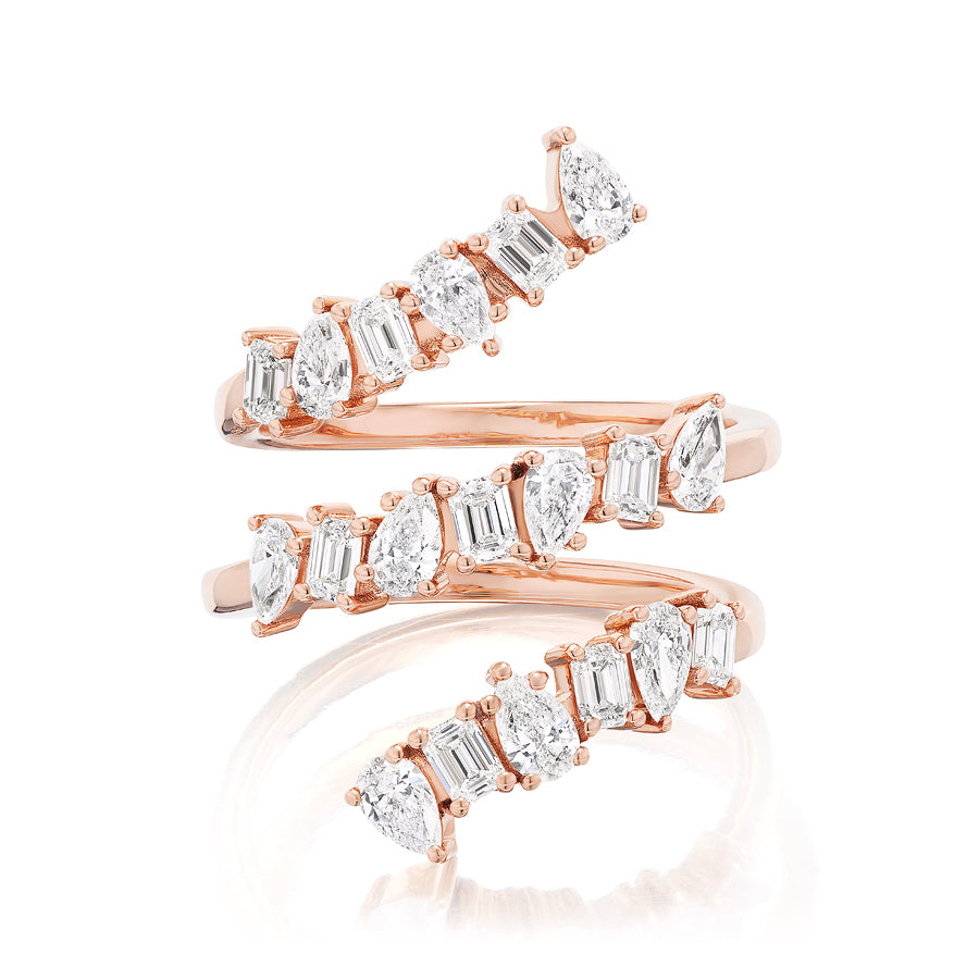 The Triple Wraparound Ring With Mixed Shape Diamonds features three overlapping 18k rose gold bands, each set with oval, marquise, and baguette cut diamonds arranged in an eye-catching alternating pattern.
