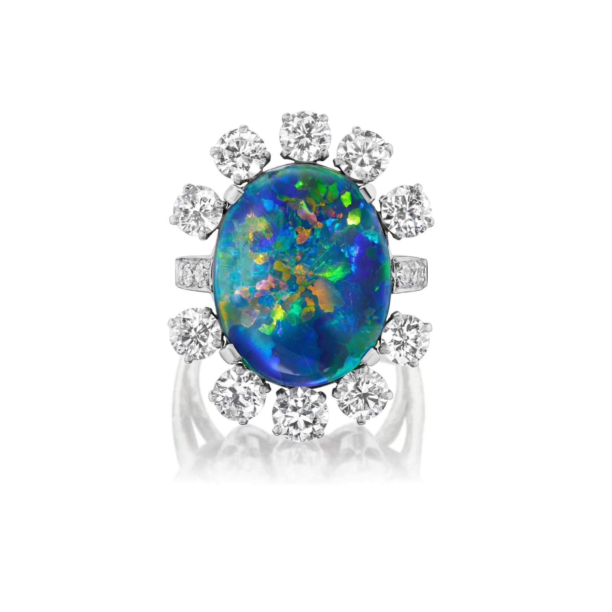 The Sunburst Oval Opal Ring features a vibrant opal with blue, green, and orange hues, accented by a halo of round brilliant diamonds and pavé, set in silver.