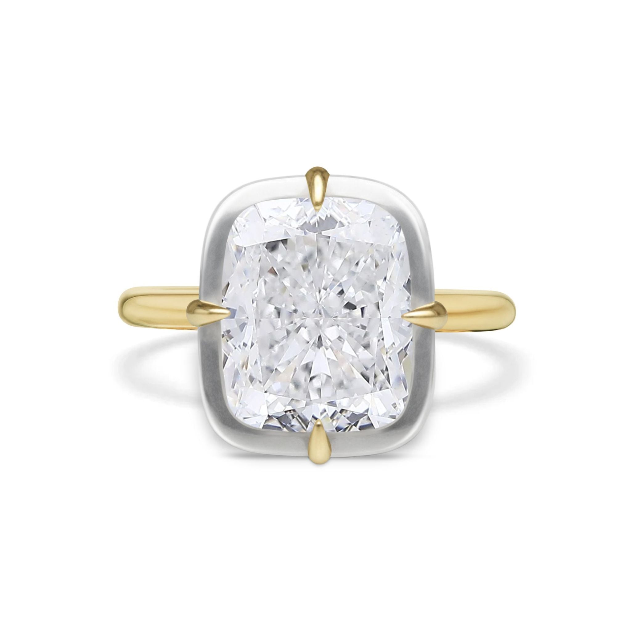 The Collet Set Cushion Cut Diamond Engagement Ring features a cushion-cut diamond held by four yellow gold prongs, with a white gold setting and yellow gold band, displayed on a white background.