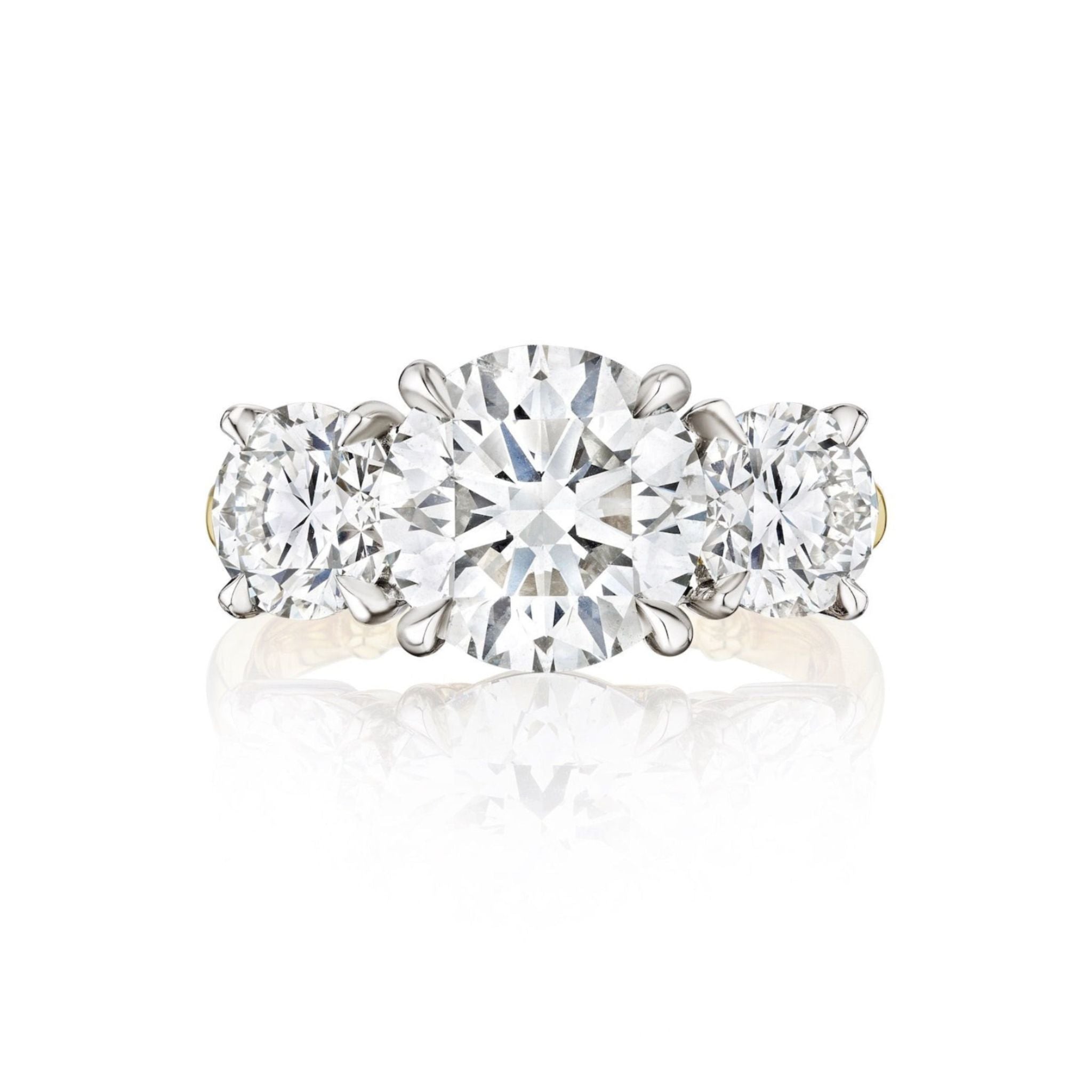 A Diamond Engagement Ring with Round Side Stones in platinum and yellow gold, featuring a brilliant center diamond flanked by sparkling side stones, displayed on a white background.