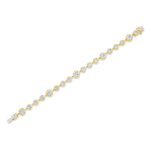The Collet Set Round Diamond Graduated Tennis Bracelet in Yellow Gold features a single row of round, bezel-set diamonds arranged in a graduated design, with the largest stones showcased at the center and tapering to smaller stones near the clasp.