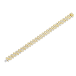 The Multi-Tier Hexagon Bezel Set Tennis Bracelet in Yellow Gold features a striking honeycomb pattern, with clusters of round diamonds set diagonally along its length and beautifully contrasted against a crisp white background.