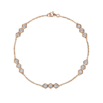 The Serpentine Station Bracelet with Hexagon Diamond Trios features a delicate 18k gold fine chain, elegantly adorned with symmetrically arranged hexagonal settings. Each station showcases a trio of sparkling round brilliant diamonds of SI1-SI2 clarity, adding refined brilliance along the length of the bracelet.