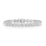 The Round Brilliant Diamond Tennis Bracelet in White Gold, featuring a continuous row of sparkling diamonds, is elegantly displayed on a white background.