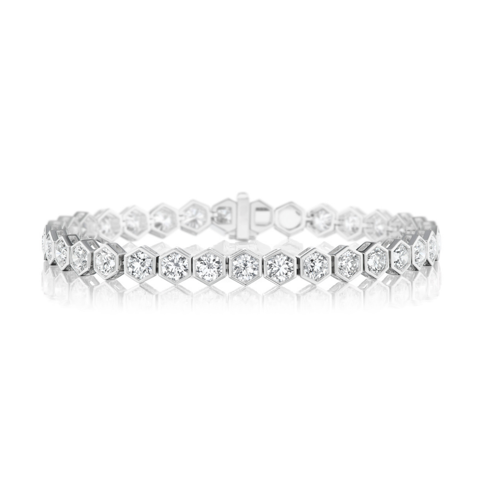 The Large Hexagon Bezel Set Diamond Tennis Bracelet, crafted in silver with hexagonal links—each adorned with round brilliant diamonds—rests elegantly on a white reflective surface.