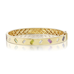 Introducing the Mixed Shape Diamond and Multicolor Sapphire Bangle: a luxurious 18k yellow gold bracelet featuring a geometric lattice interior and an artful array of rectangular gemstones, including baguette cut diamonds and emerald cut sapphires, set across its surface.