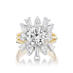 The Confetti Diamond Ring Jacket in White and Yellow Gold features a stunning gold ring with a striking round center diamond, encircled by a radiant halo of baguette, pear, and marquise diamonds set in white metal prongs. The addition of the distinctive ring jacket beautifully accentuates the brilliance of the design and brings a modern flair to the timeless yellow gold band.