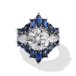 The Baguette and Marquise Sapphire Engagement Ring Jacket in White Gold showcases a striking round center diamond, encircled by marquise, pear, and baguette-cut sapphires and accented with smaller diamonds.