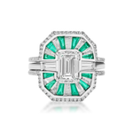 Introducing the Mosaic Tapered Baguette Emerald and Diamond Ring Jacket in White Gold, featuring a large rectangular central diamond set in a geometric design with green baguette emeralds and clear baguette-cut stones, complemented by a striking double band and paired with a pavé diamond band for added brilliance.