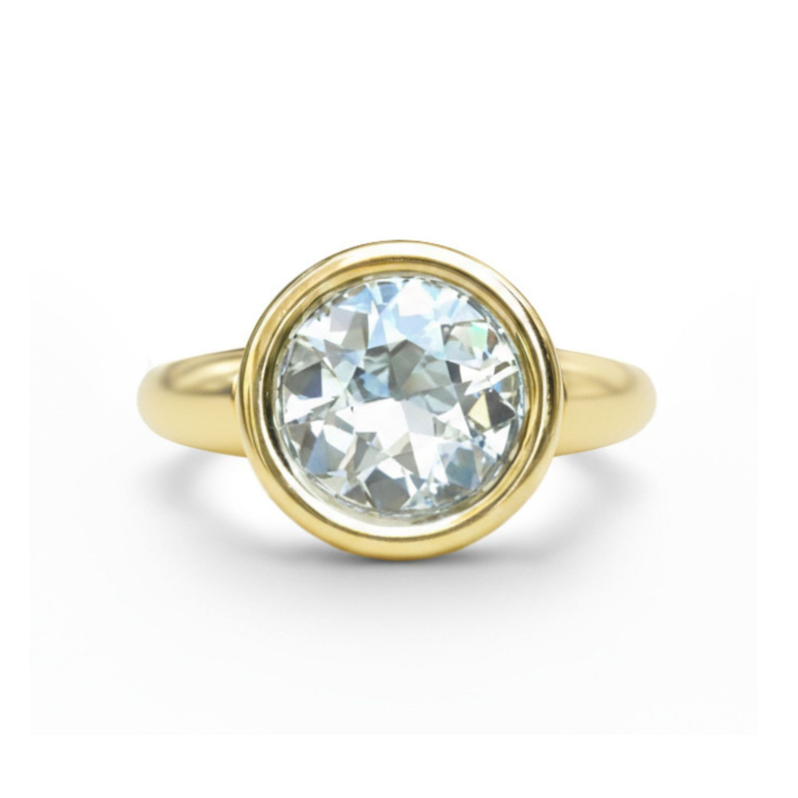 A Bezel Set Round Diamond Engagement Ring in Yellow Gold is displayed against a plain white background.