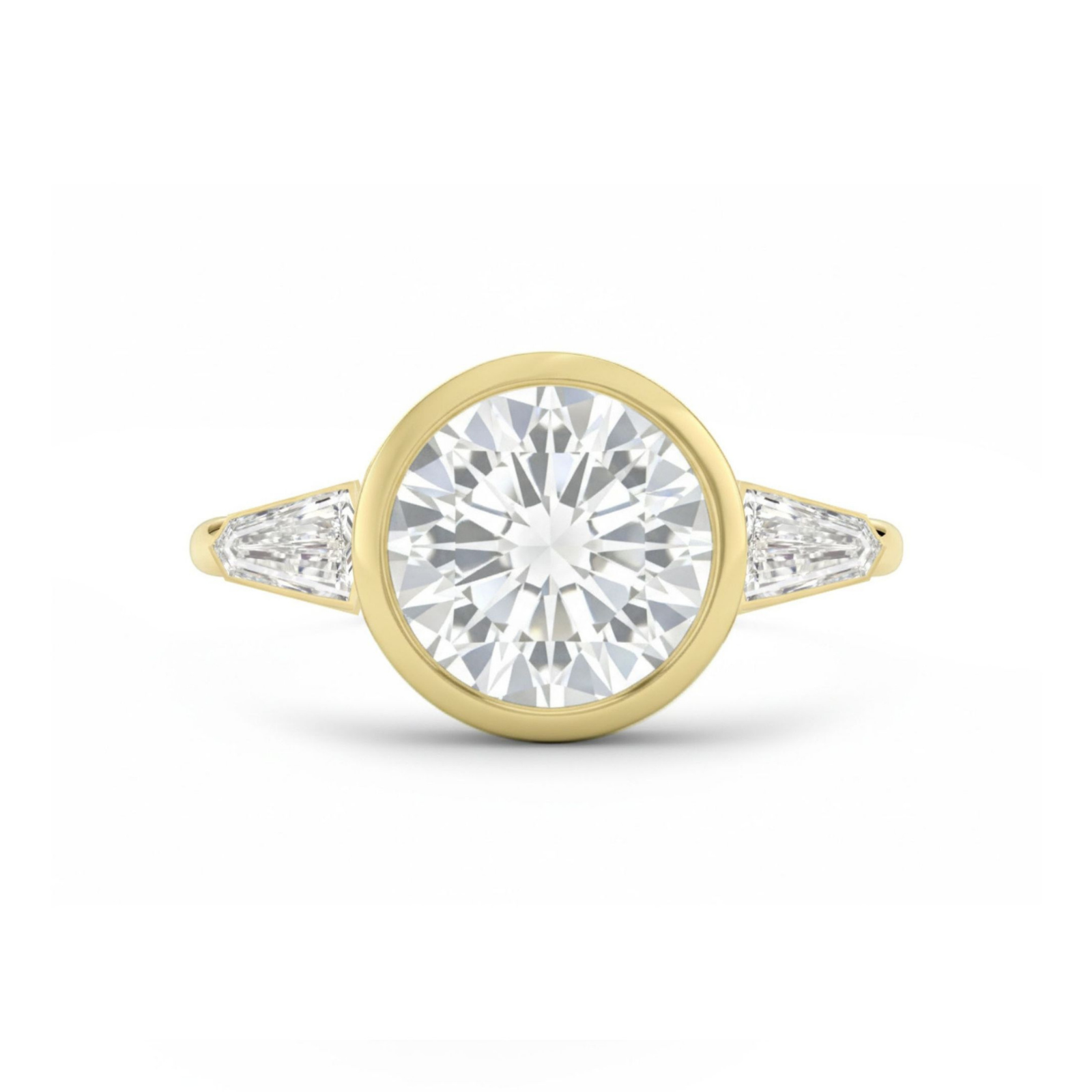 A yellow gold engagement ring featuring a bezel-set round center diamond, accented by tapered baguette side stones, displayed on a white background.