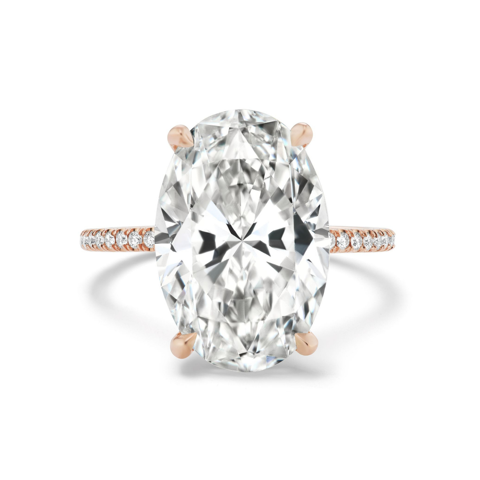 The Oval Diamond Engagement Ring Pavé Band showcases a stunning large oval-cut diamond center stone set in an elegant 18K rose gold band, accented with delicately pavé-set small diamonds and beautifully photographed against a white background.