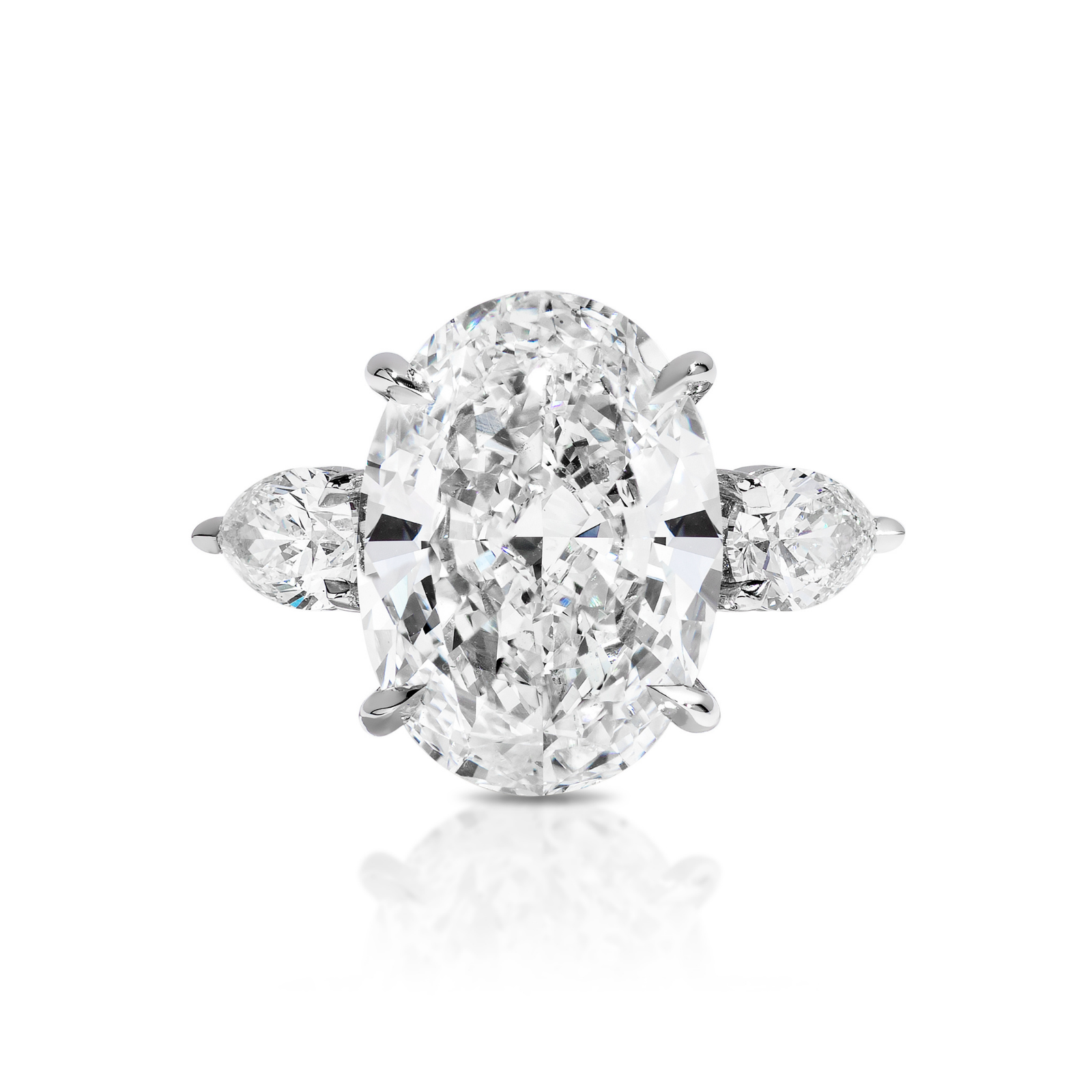 A white gold Oval Diamond Engagement Ring with Pear Side Stones, showcasing a large oval-cut diamond centerpiece accented by two elegant pear-shaped diamonds on each side, displayed on a white background. Perfect for those seeking unique bridal rings or celebration rings to commemorate life’s most special moments.