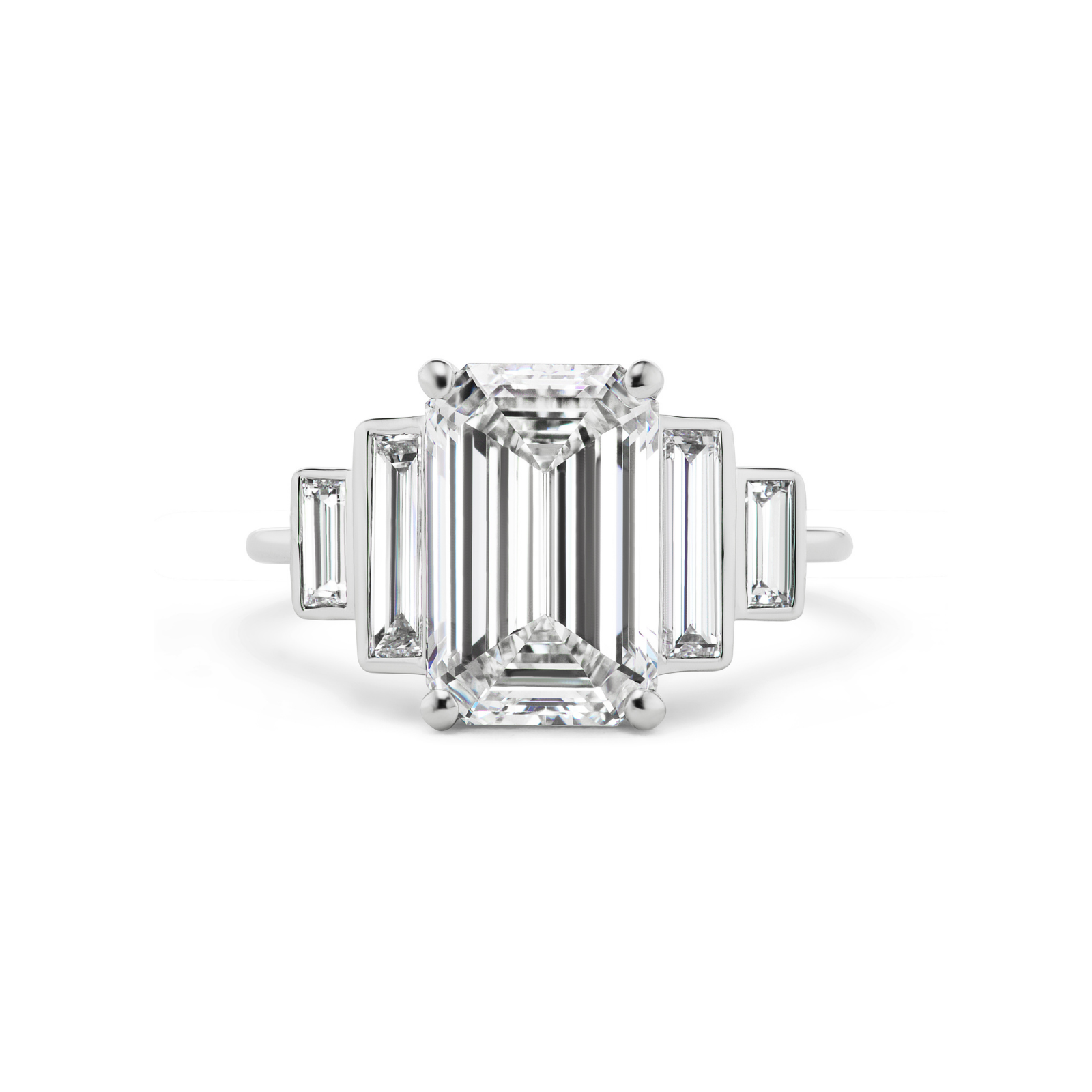 The Echo Emerald Cut Diamond Engagement Ring showcases a striking rectangular emerald-cut diamond at its center, accented by bezel-set tapered baguette side stones, all elegantly crafted in polished 18K white gold and displayed on a white background.