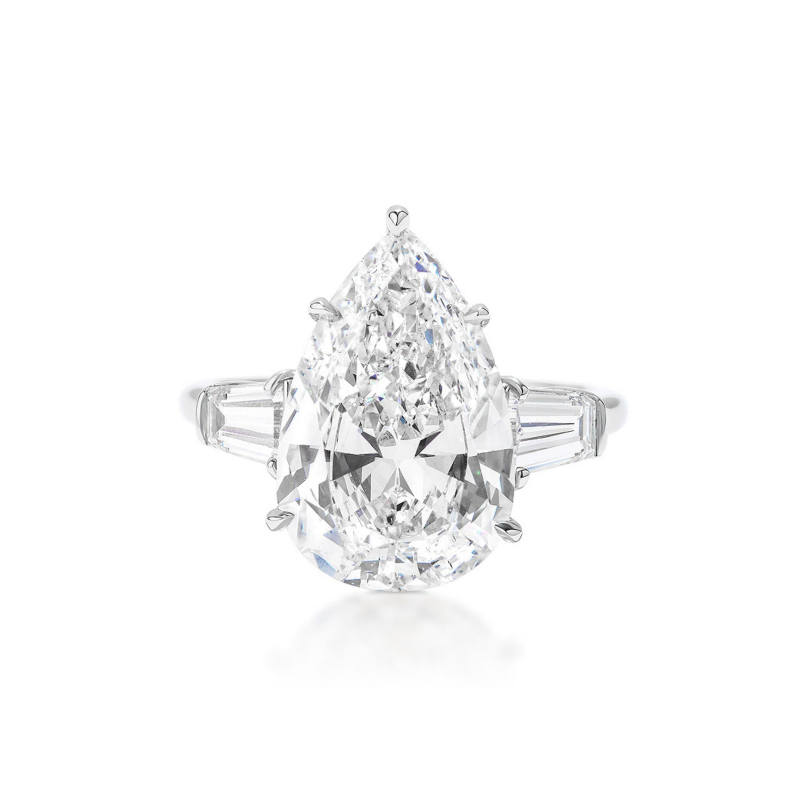 The Pear Shape Diamond Engagement Ring with Tapered Baguette Side Stones showcases a striking pear-shaped diamond at its center, accented by elegant tapered baguette diamonds on each side and set in platinum. Presented against a white background, this exquisite ring is an ideal choice for celebrating life's most cherished moments.