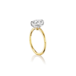 A dazzling 18K yellow gold ring featuring a diagonally set pear-shaped diamond solitaire in a white prong setting, showcased upright against a white background.