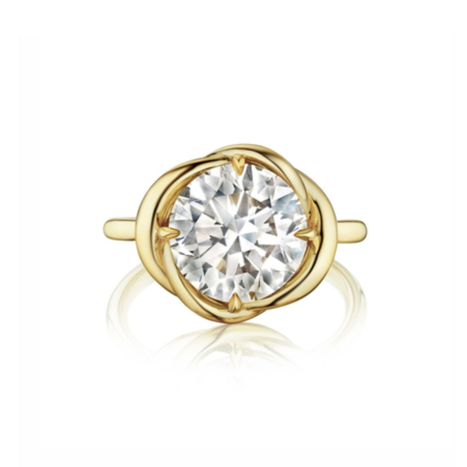 A Round Brilliant Diamond Engagement Ring featuring a large round center diamond held by four prongs, showcased within an intertwining yellow gold design, displayed on a white background.