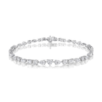 Showcased on a white background with a subtle reflection, the Heart Shape Centered Mixed Shape Prong Set Diamond Tennis Bracelet shines in your choice of 18k gold or platinum, featuring an array of diamond cuts accented by heart-shaped center stones.