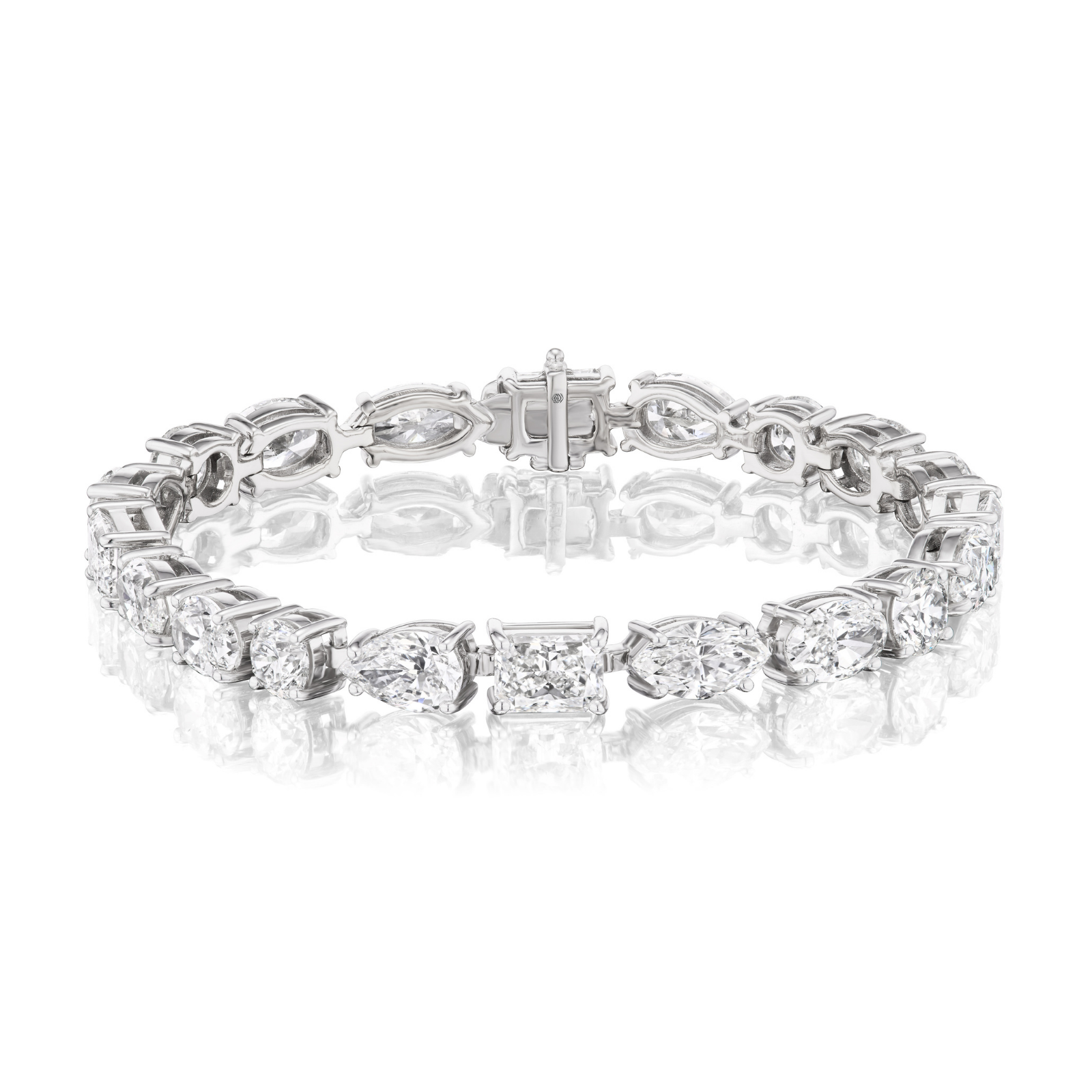 The Large East-West Mixed Shape Diamond Tennis Bracelet, crafted in 18k white gold with G-H color mixed shape diamonds—alternating pear, marquise, and rectangular cuts—is displayed against a white background.