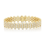 The Multi-Tier Hexagon Bezel Set Tennis Bracelet in Yellow Gold showcases a striking honeycomb pattern crafted in 18k yellow gold, adorned with small round diamonds, each bezel set to enhance brilliance. Presented on a white background.