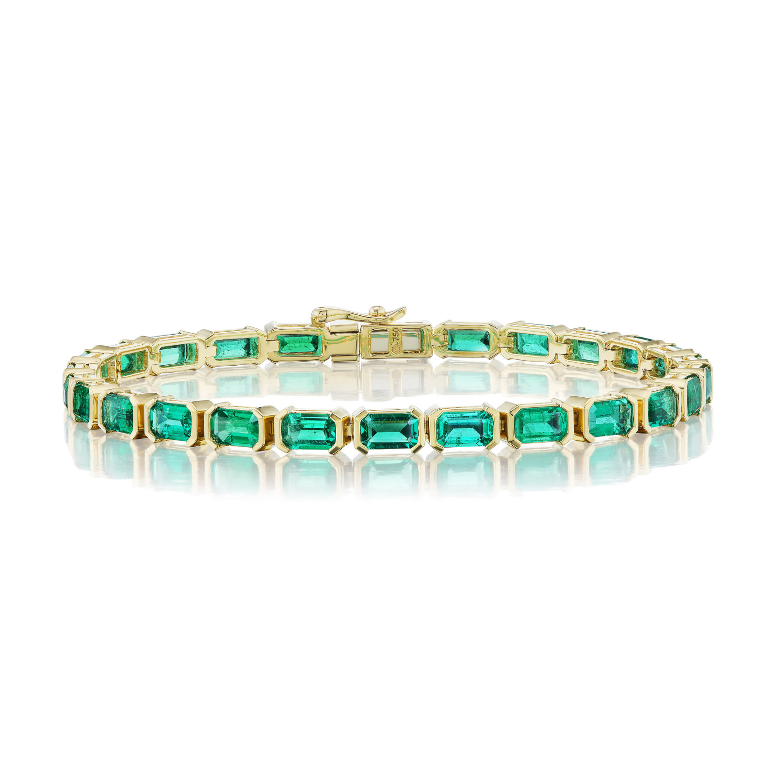 The East-West Set Emerald Cut Emerald Tennis Bracelet in Yellow Gold is elegantly displayed on a reflective white surface.